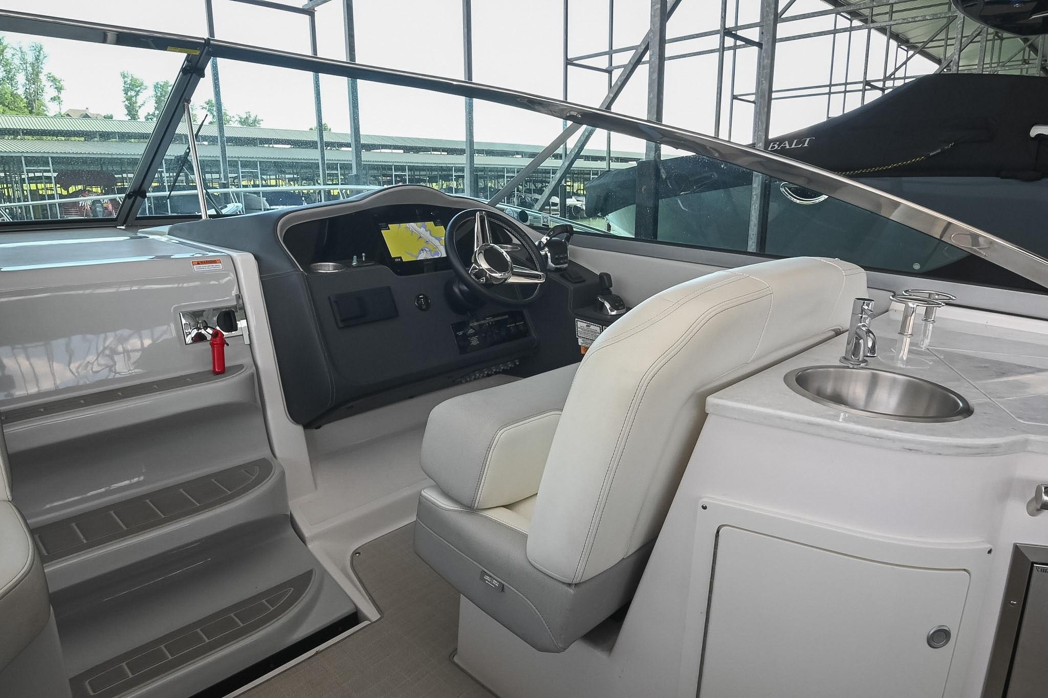 2021 Regal 33 Express boat interior with helm, steering wheel, and sink.