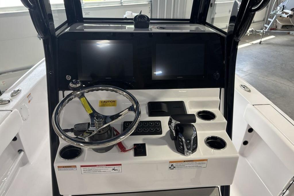 2026 Sportsman Masters 247 Bay Boat dashboard with steering wheel and dual screens.