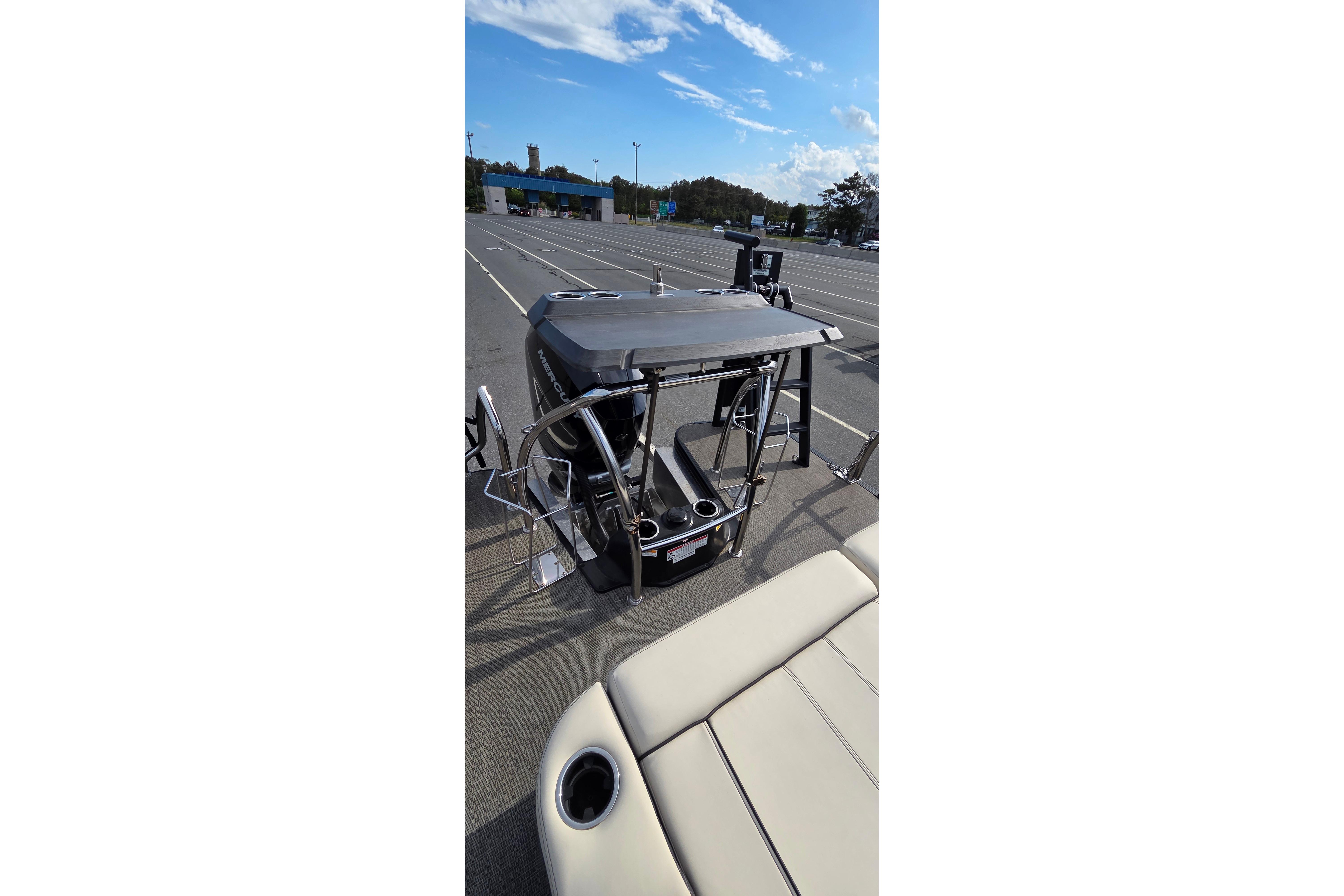2025 Barletta Lusso 25UCA pontoon boat with sleek design in a parking lot.