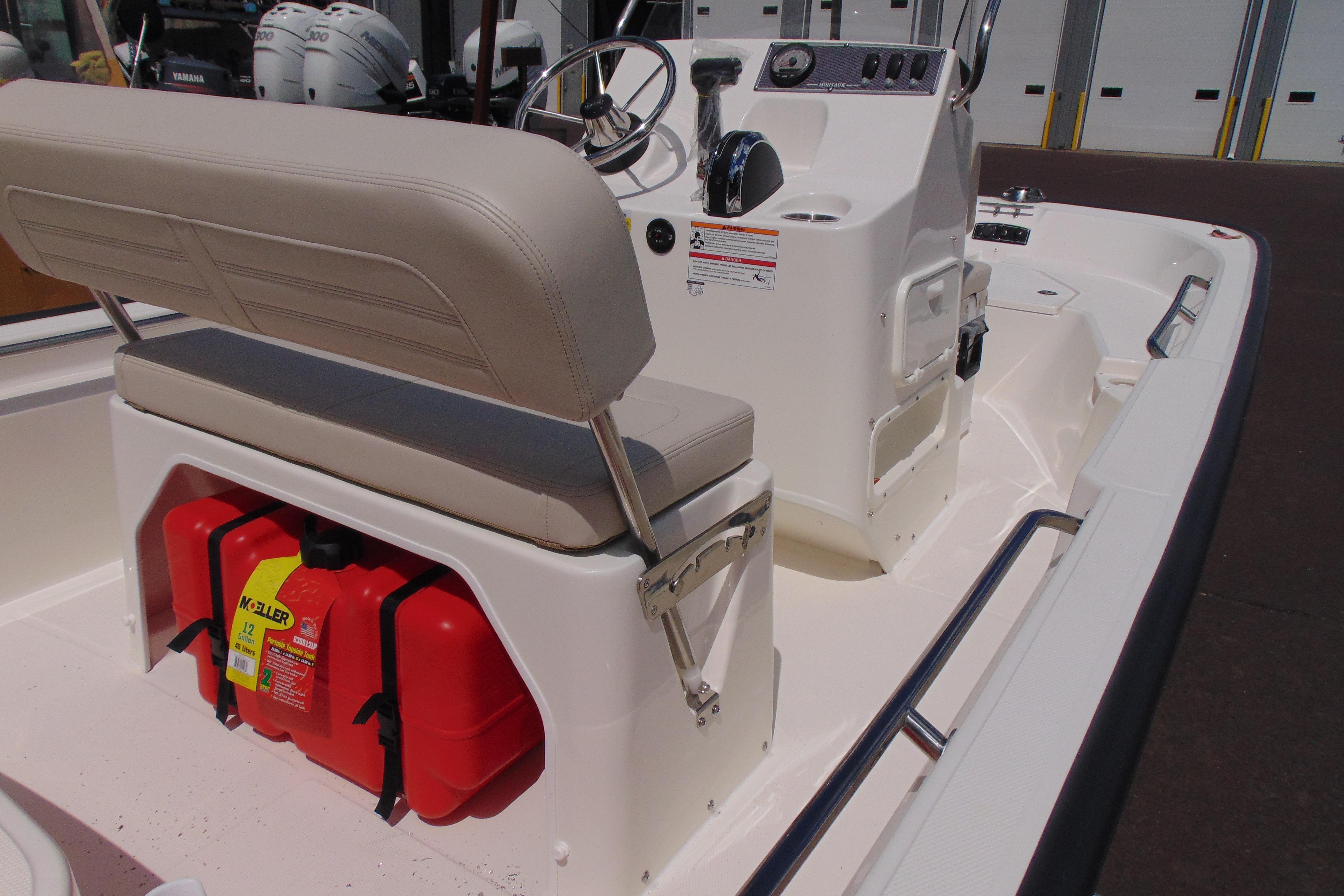 2026 Boston Whaler 150 Montauk boat interior with seating and storage compartments.