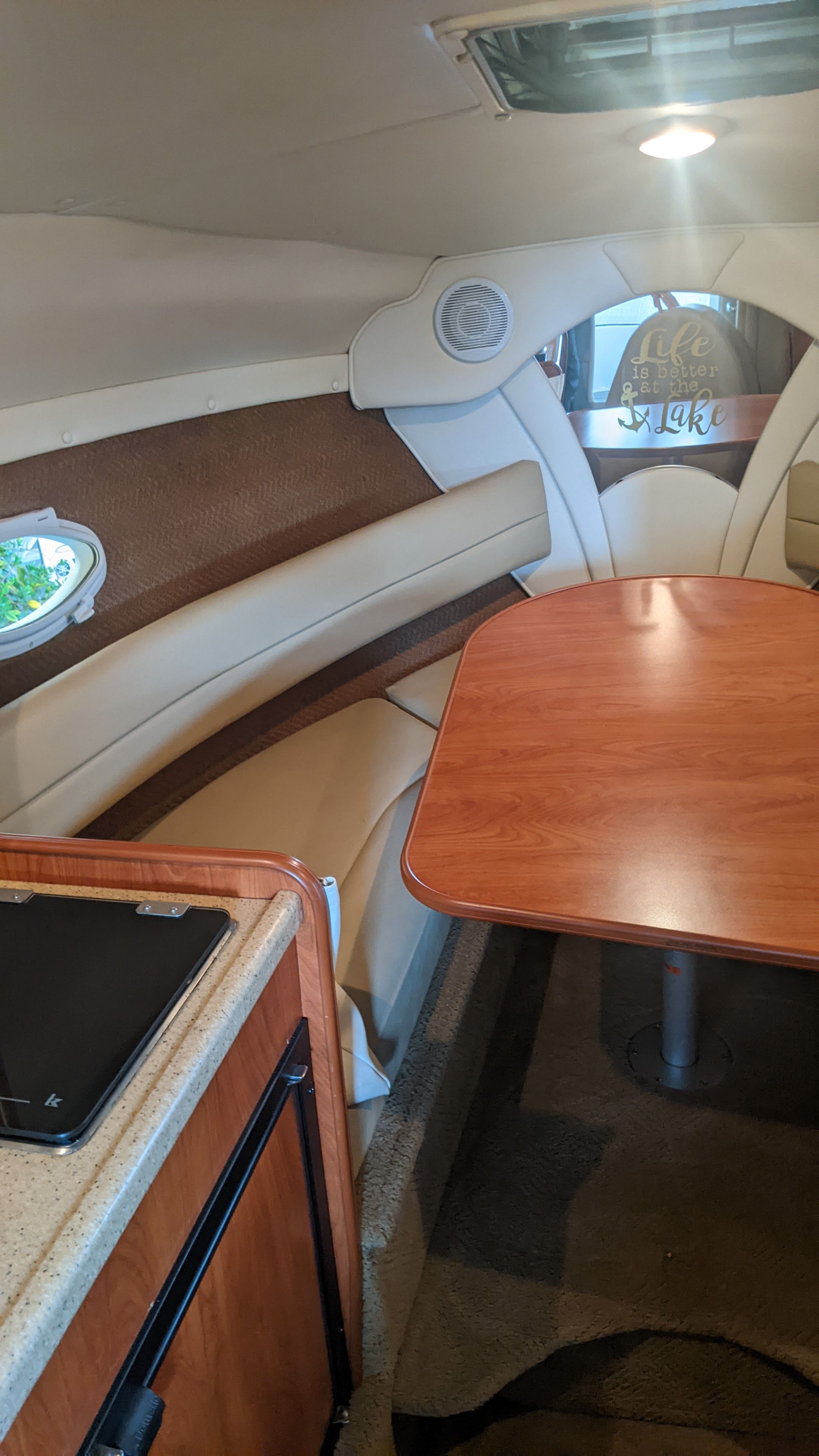 Interior of a 2006 Rinker 250 EC yacht with table and seating area.
