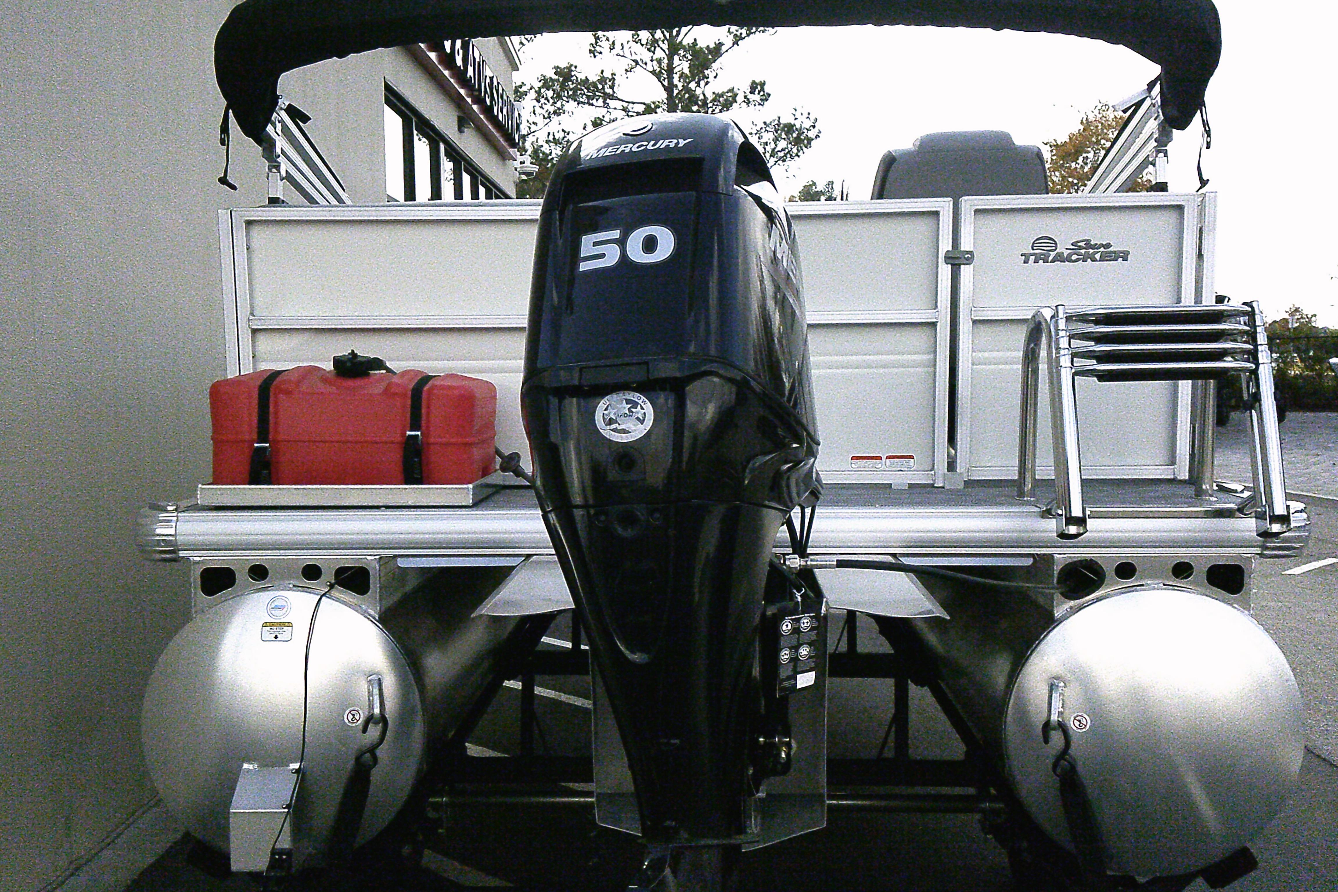 2026 Sun Tracker Party Barge 16 DLX with Mercury 50 engine, rear view.