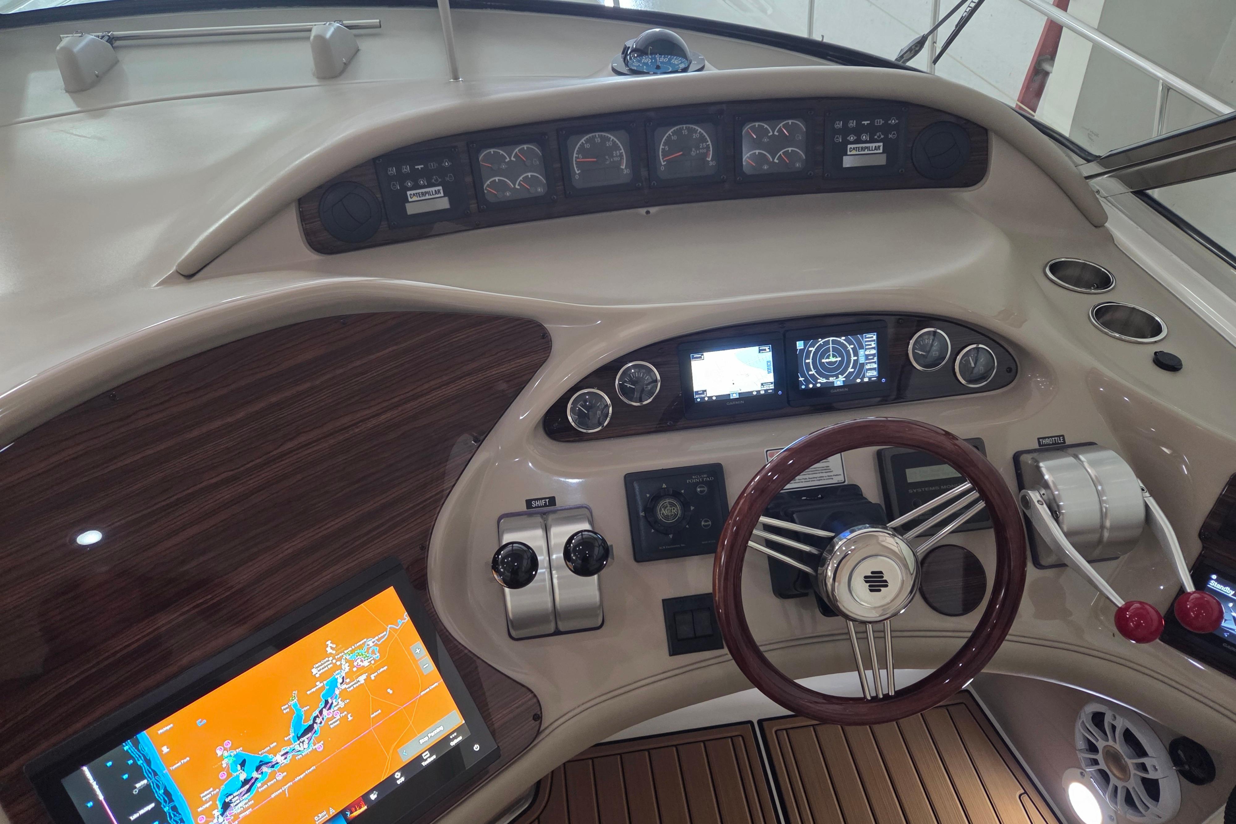 Cockpit of 2000 Sea Ray Sundancer 540 with navigation screens and controls.