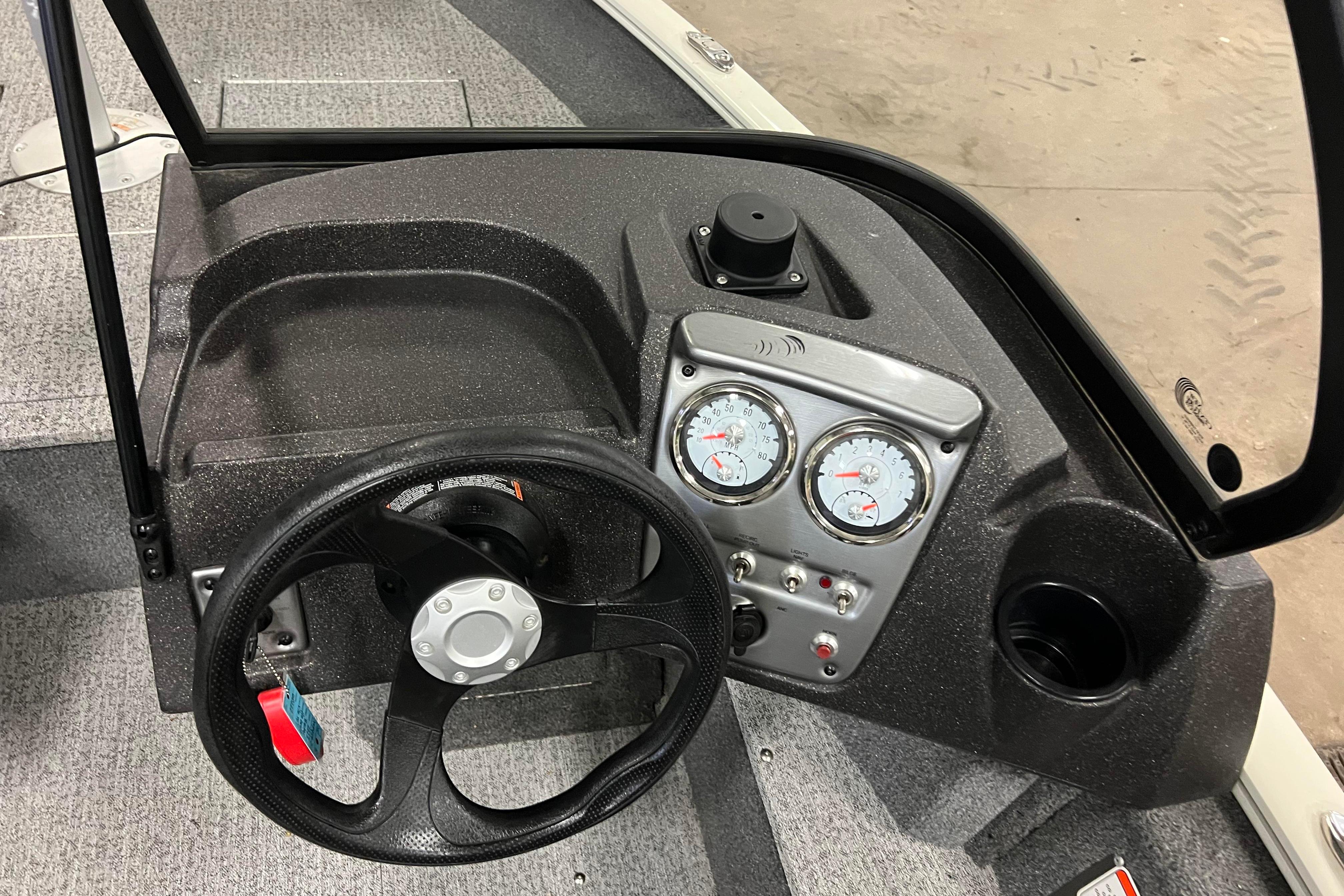 2022 Tracker Pro Guide V-16 WT boat dashboard with steering wheel and gauges.