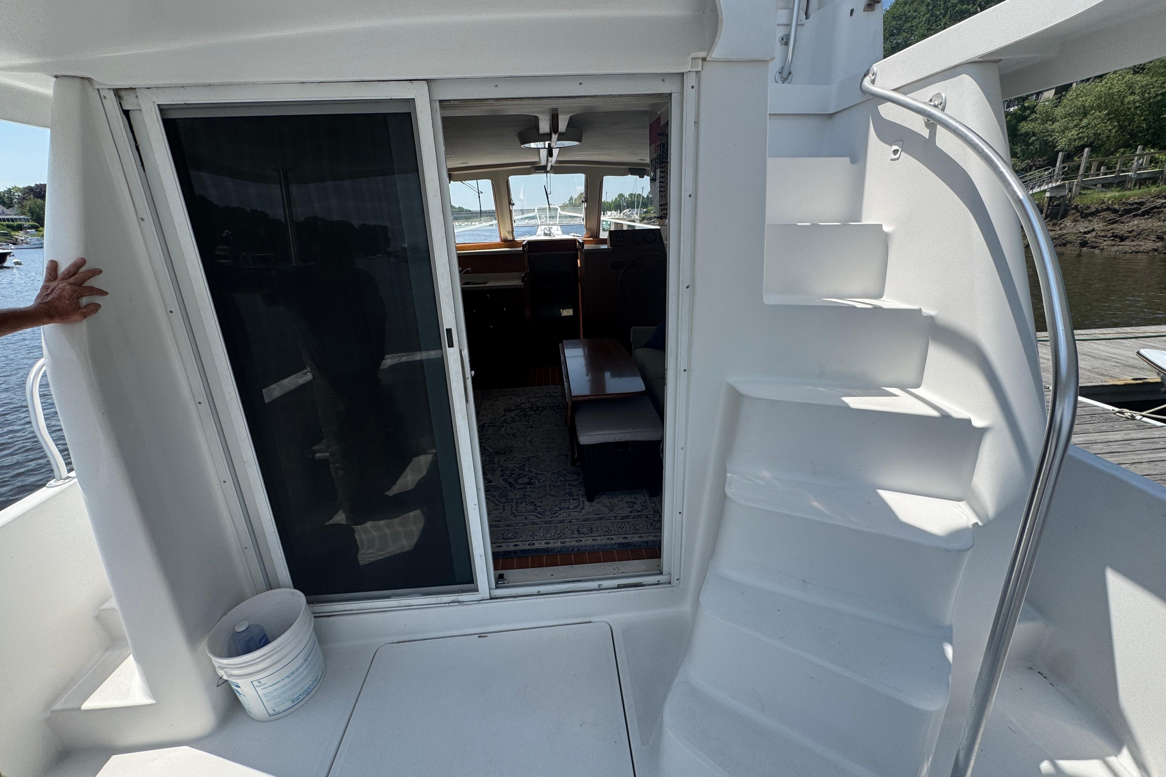 2002 Mainship 390 Trawler interior view with stairs and sliding door.