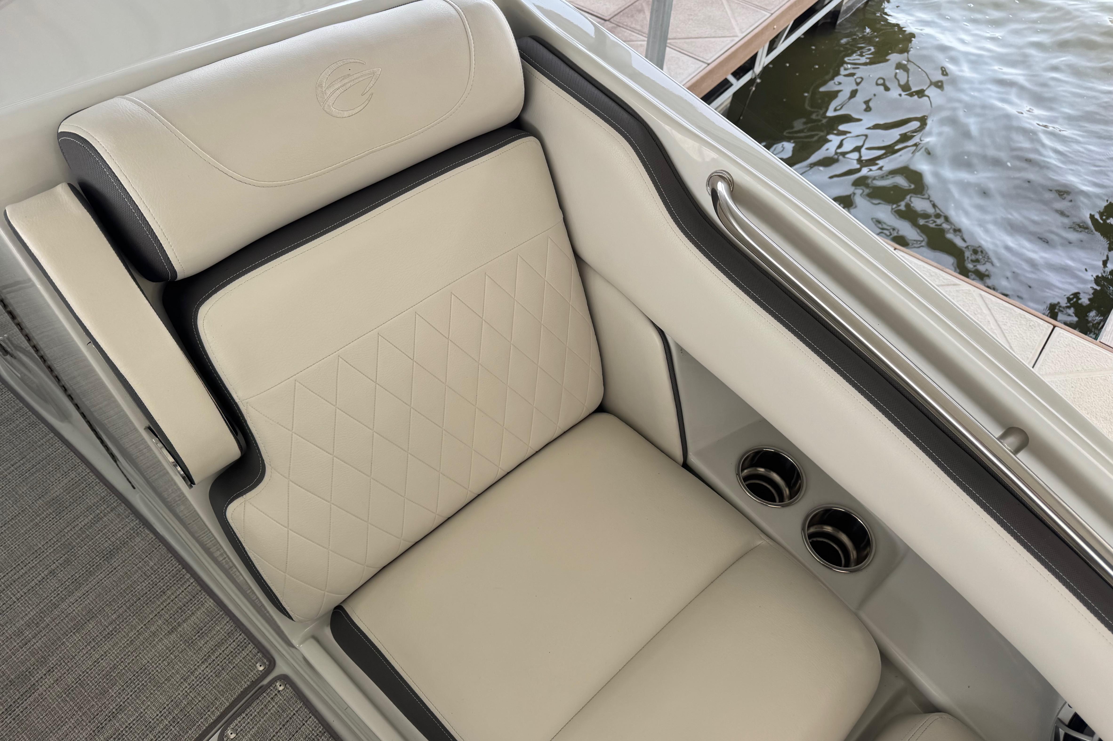 Luxurious seating on 2022 Crownline 265 SS boat, featuring elegant beige upholstery and cup holders.