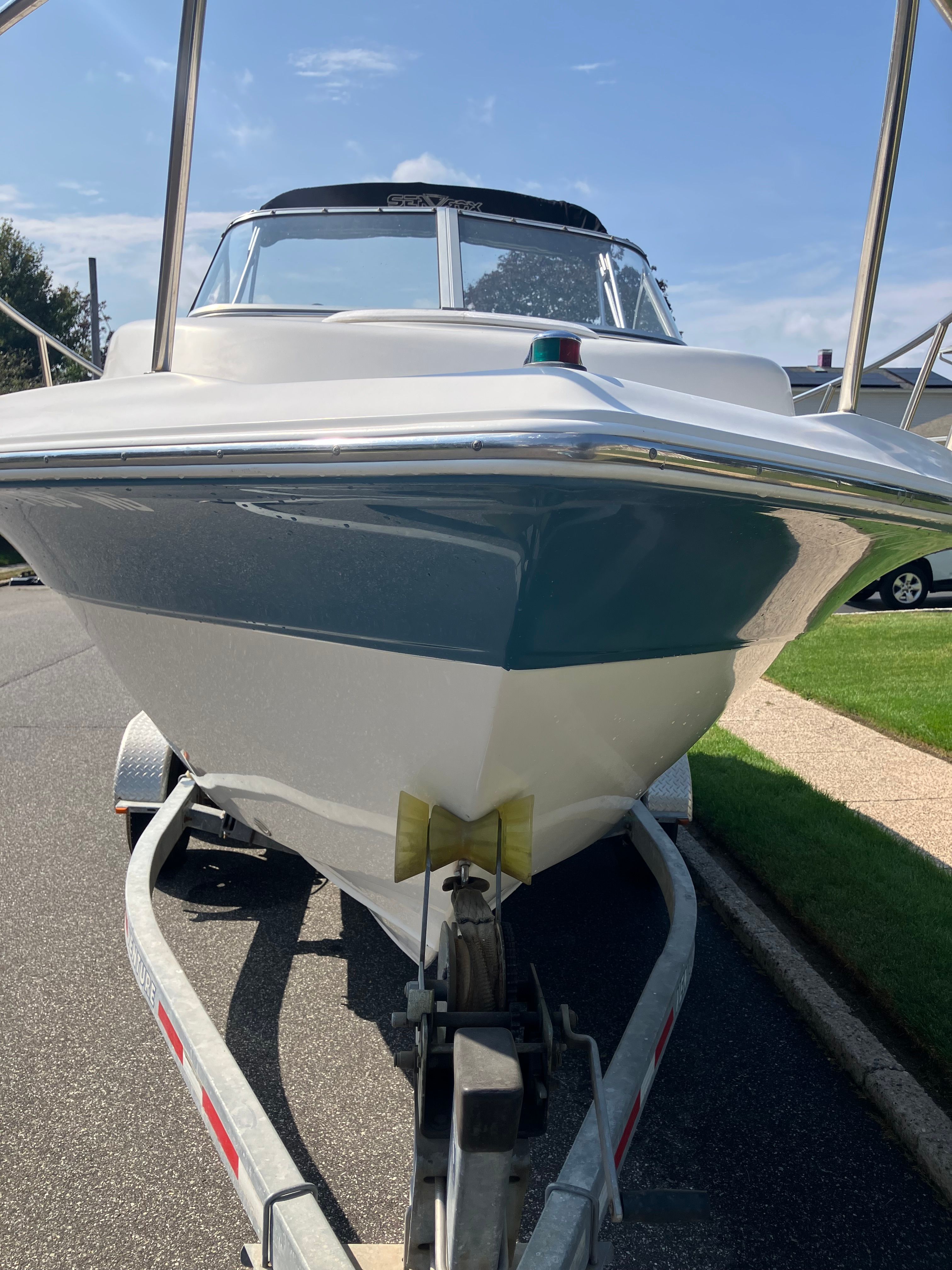 Custom 216wa pro boat from 2010 on trailer, front view.