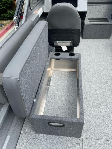 2025 Spartan 200 Astoria boat interior with storage compartment and seating.