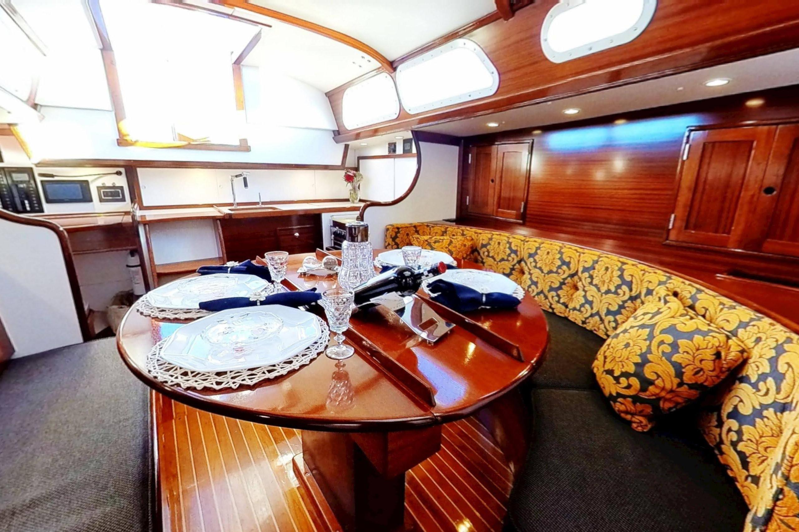 Luxurious 1970 Hinckley Bermuda 40 yacht interior with elegant dining area and wooden finishes.