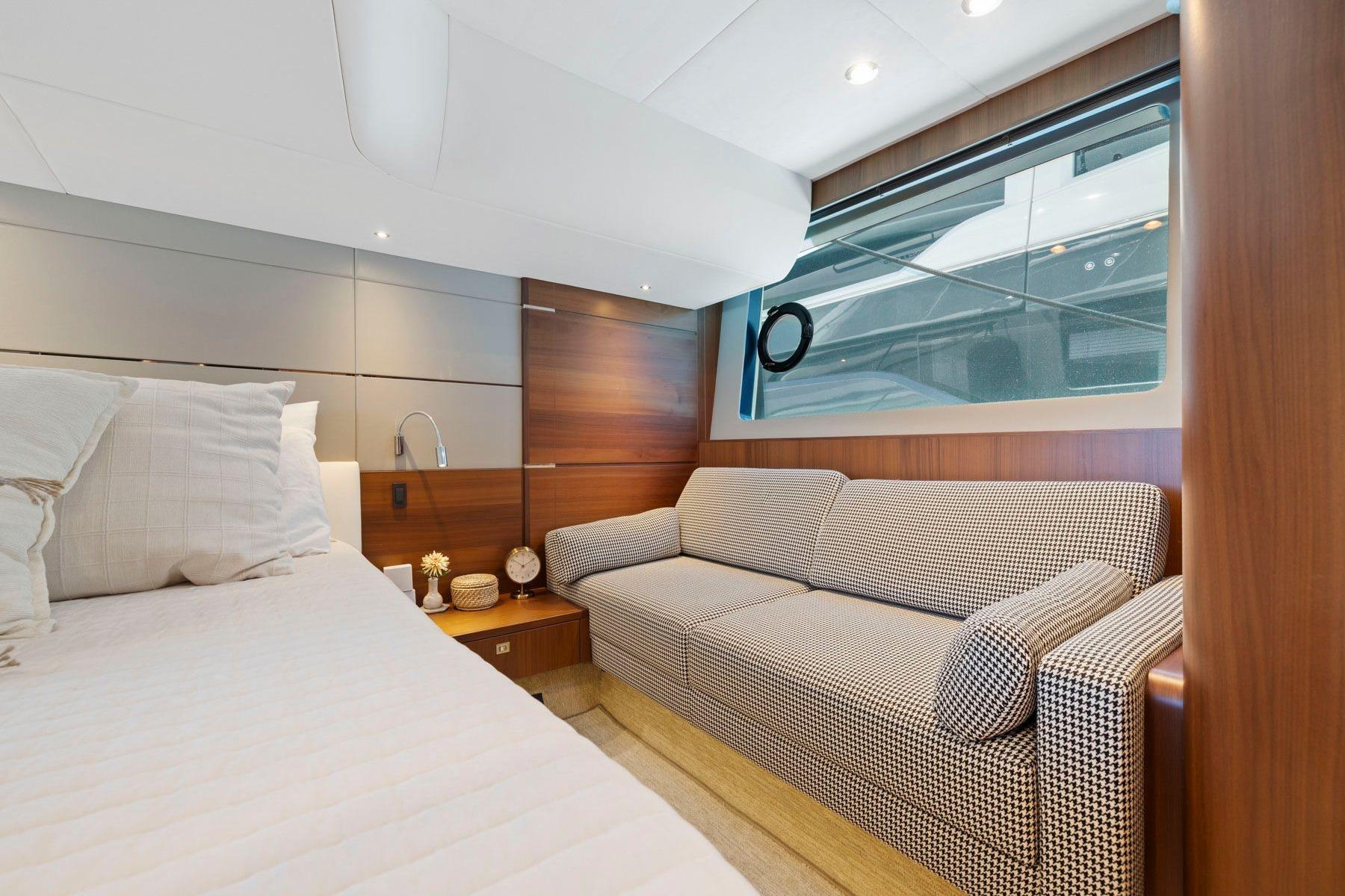 Luxurious interior of 2015 Princess 60 Flybridge Motor Yacht with elegant sofa and bed.
