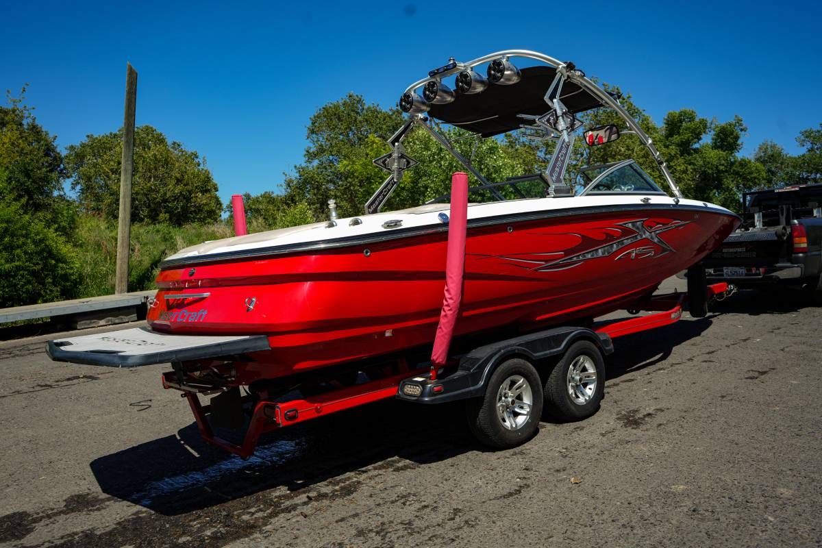 A red 2007 MasterCraft X-45 boat on a trailer, ready for use.