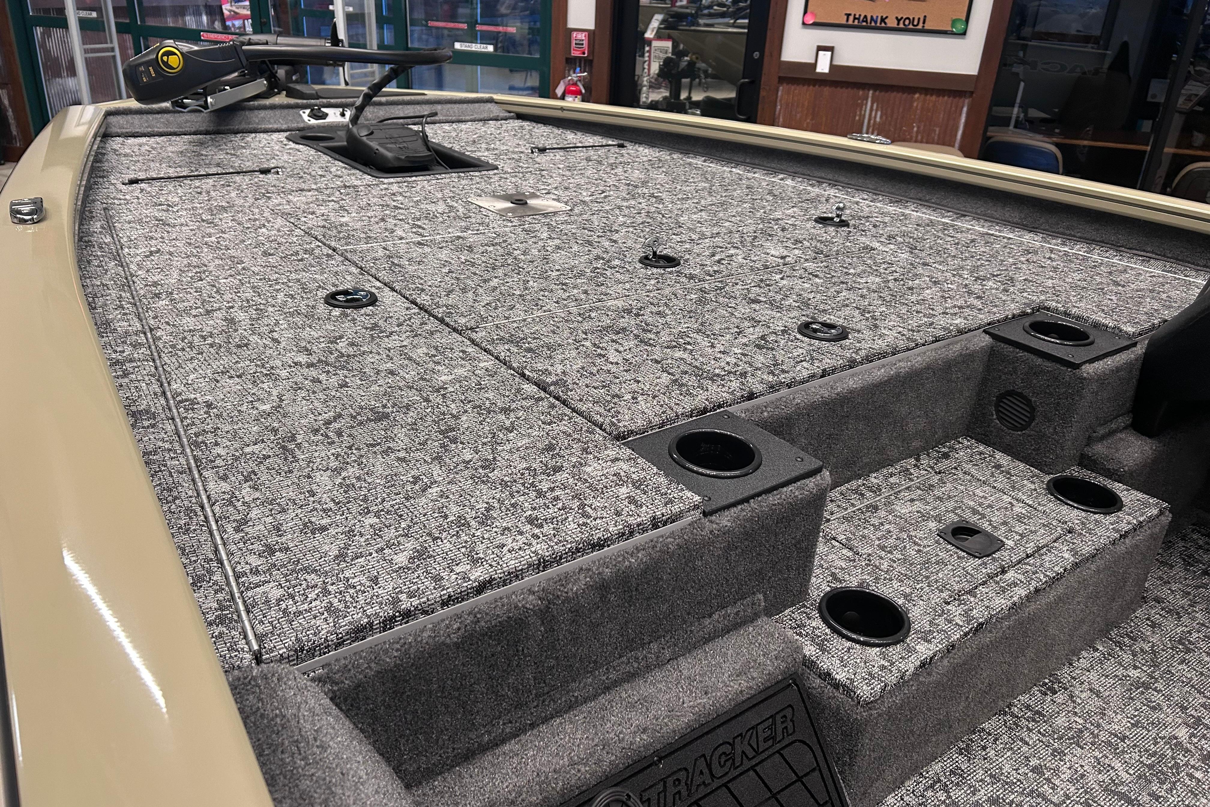 2026 Tracker Pro Team 195 boat interior with carpeted deck and storage compartments.