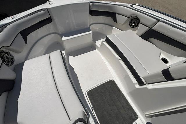 Interior seating of a 2014 Yamaha Boats 212X, featuring cushioned benches and speakers.