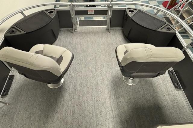 2026 Sun Tracker Bass Buggy 18 DLX interior with two swivel seats and carpeted flooring.