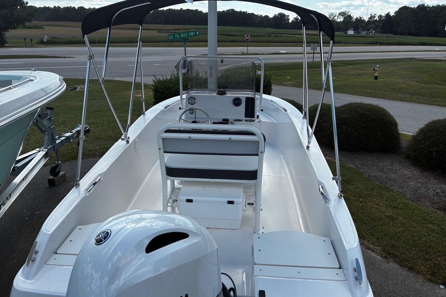 2026 Robalo R160 Center Console boat with Yamaha engine, parked near a road.
