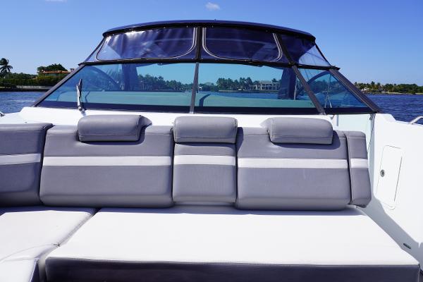 2020 Cruisers Yachts 38 GLS OB boat with gray seating and clear windshield on a sunny day.