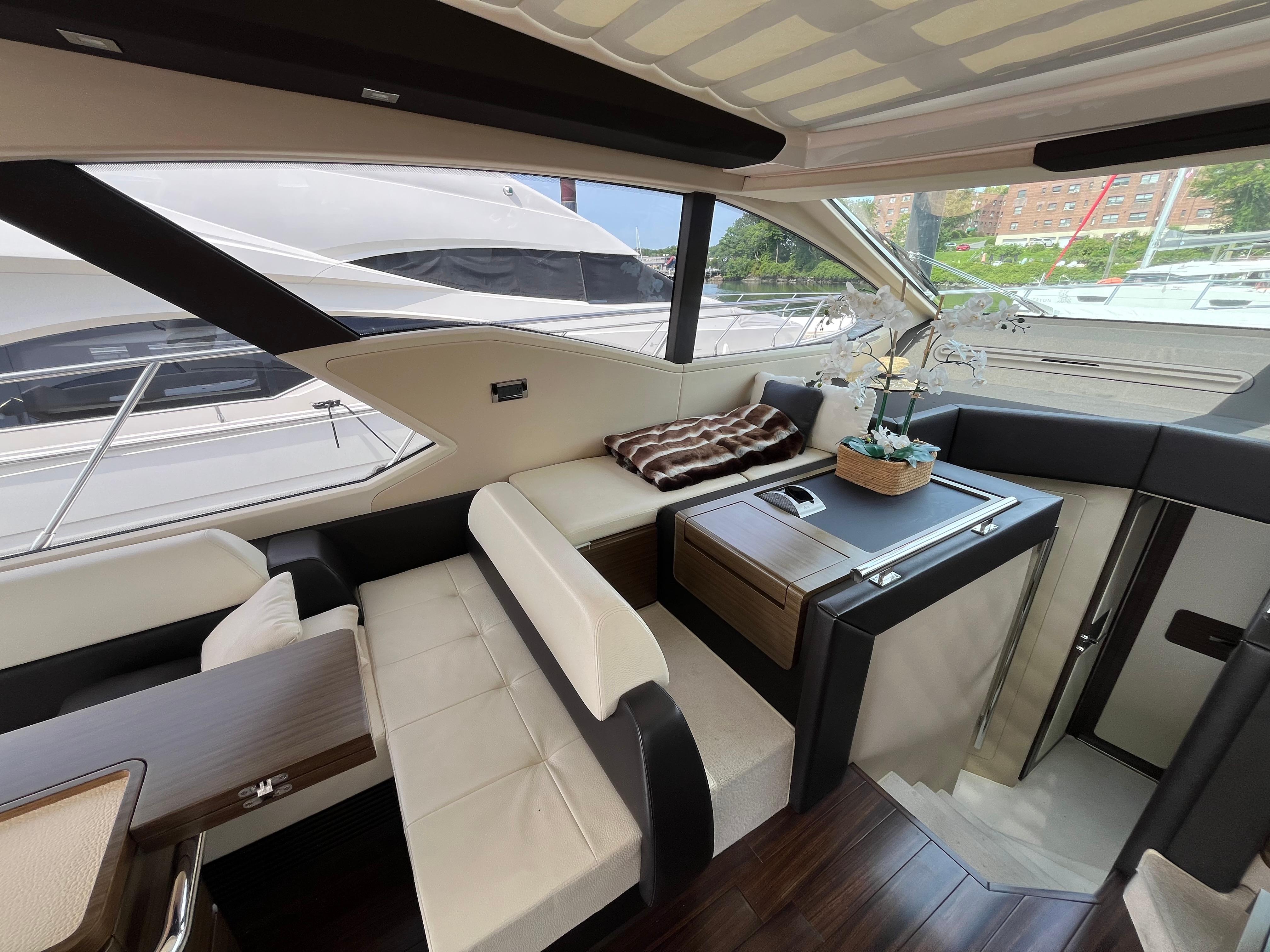 Luxurious interior of a 2014 Azimut 55S yacht with elegant seating and decor.