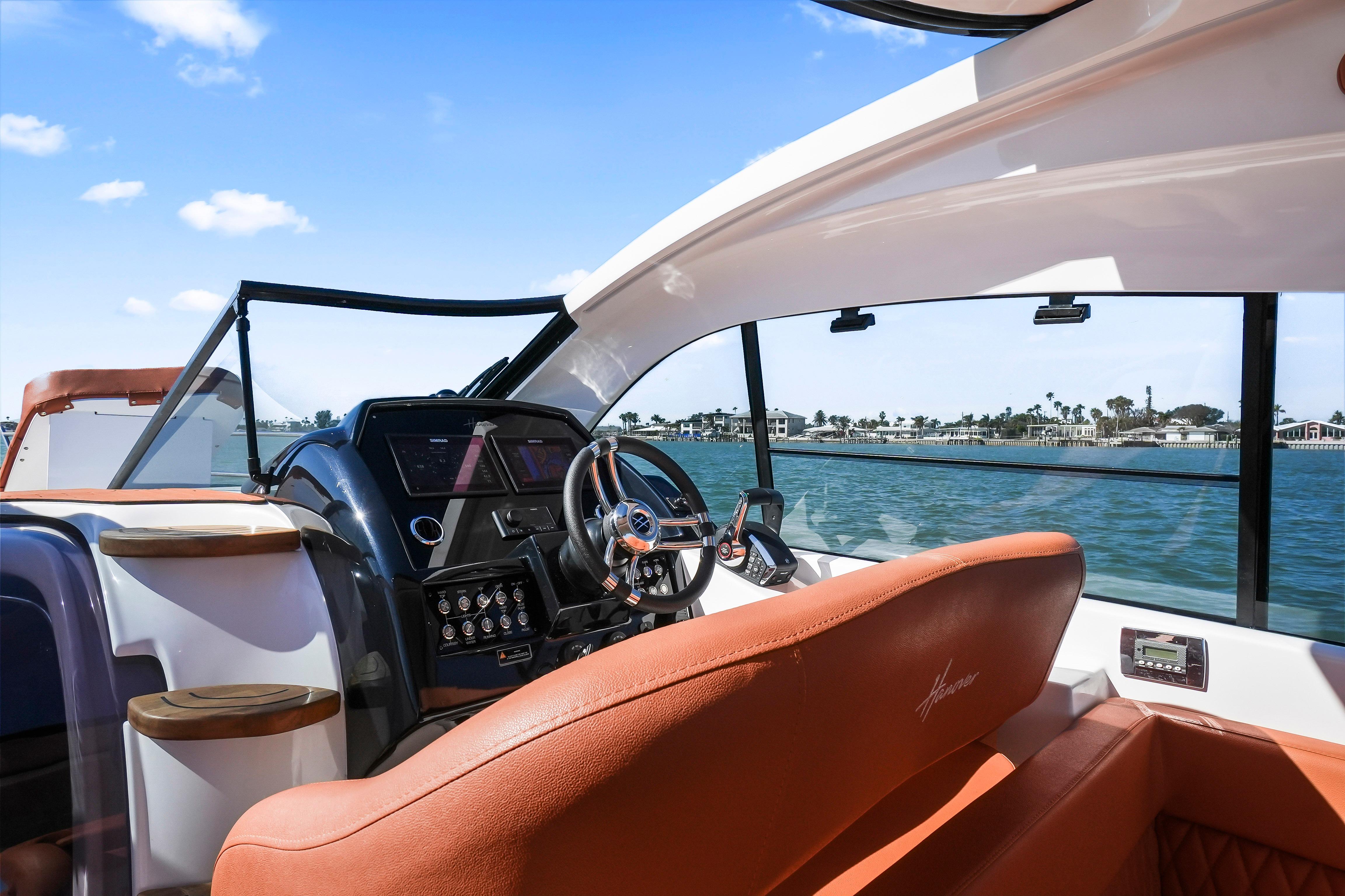 Luxurious 2026 Hanover 355 yacht interior with modern dashboard and waterfront view.