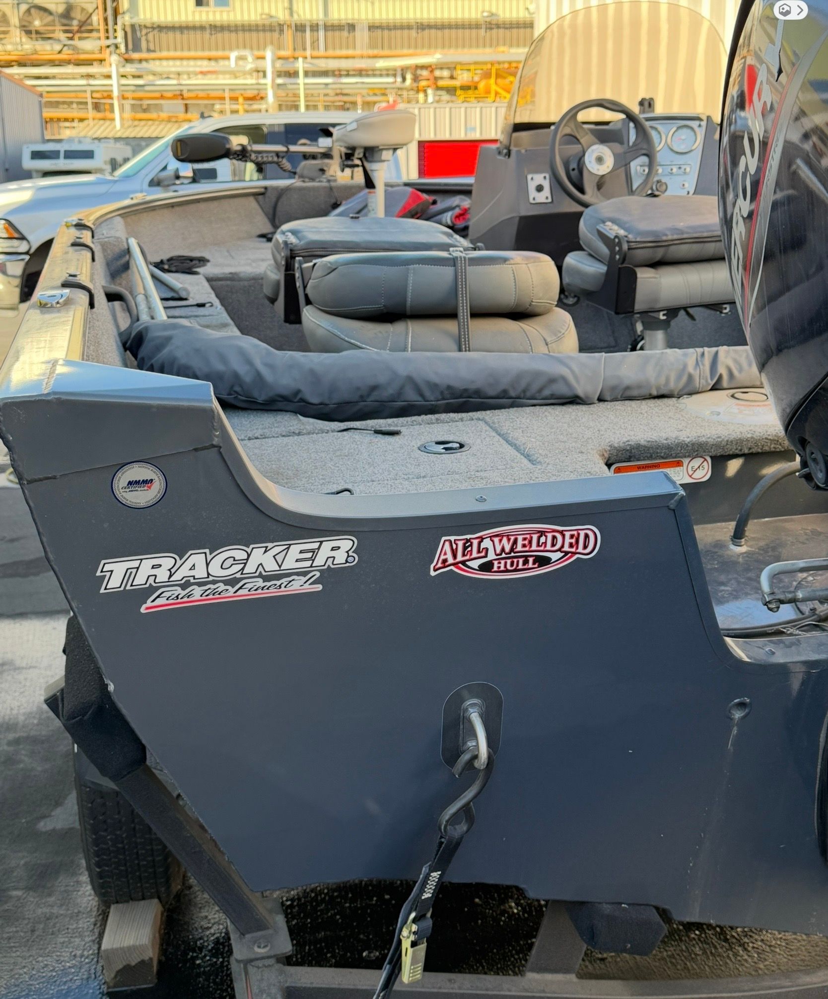 A 2021 Bass Tracker Pro Guide V 16 with gray seats and an all-welded hull.