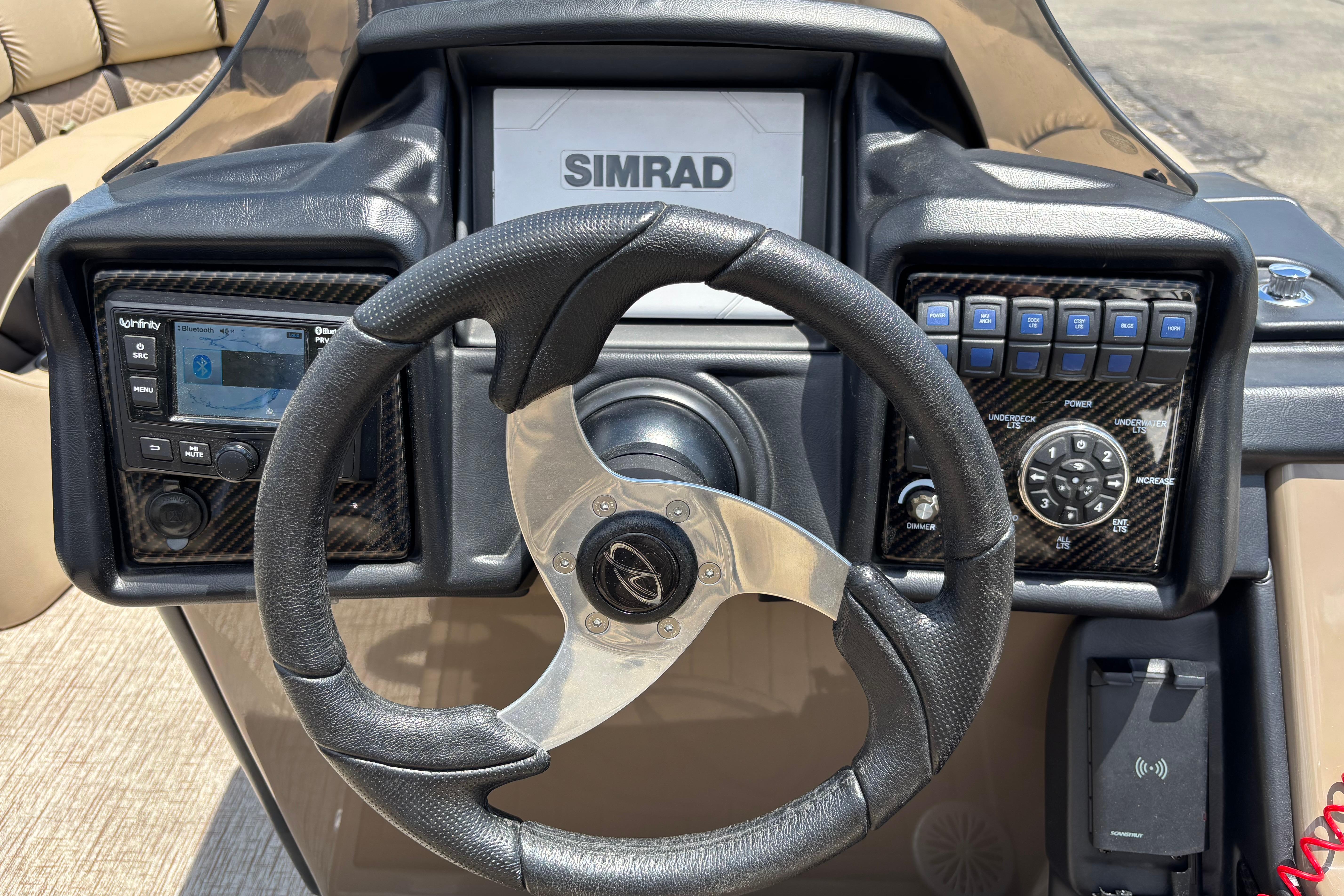 Steering console of 2021 Veranda VP25RC boat with Simrad display and controls.