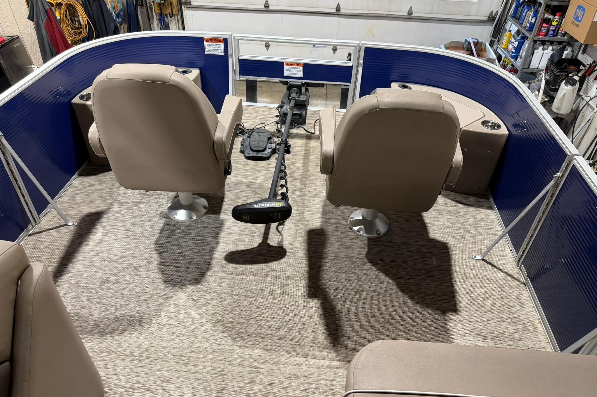 2020 Bennington SX 22 SFX pontoon boat interior with beige seats and blue paneling.