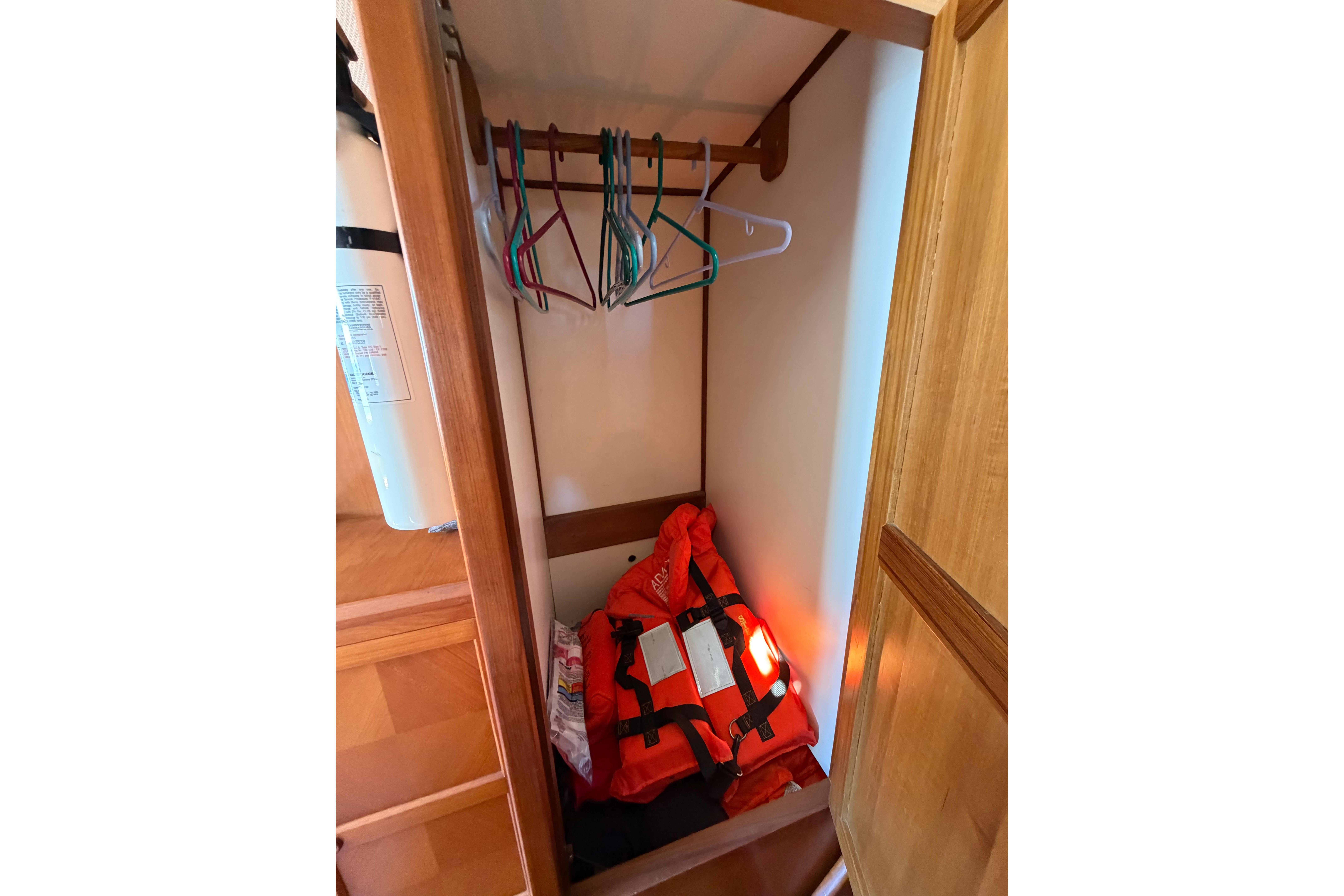 1987 Marine Trader 36 closet with life jackets and hangers.