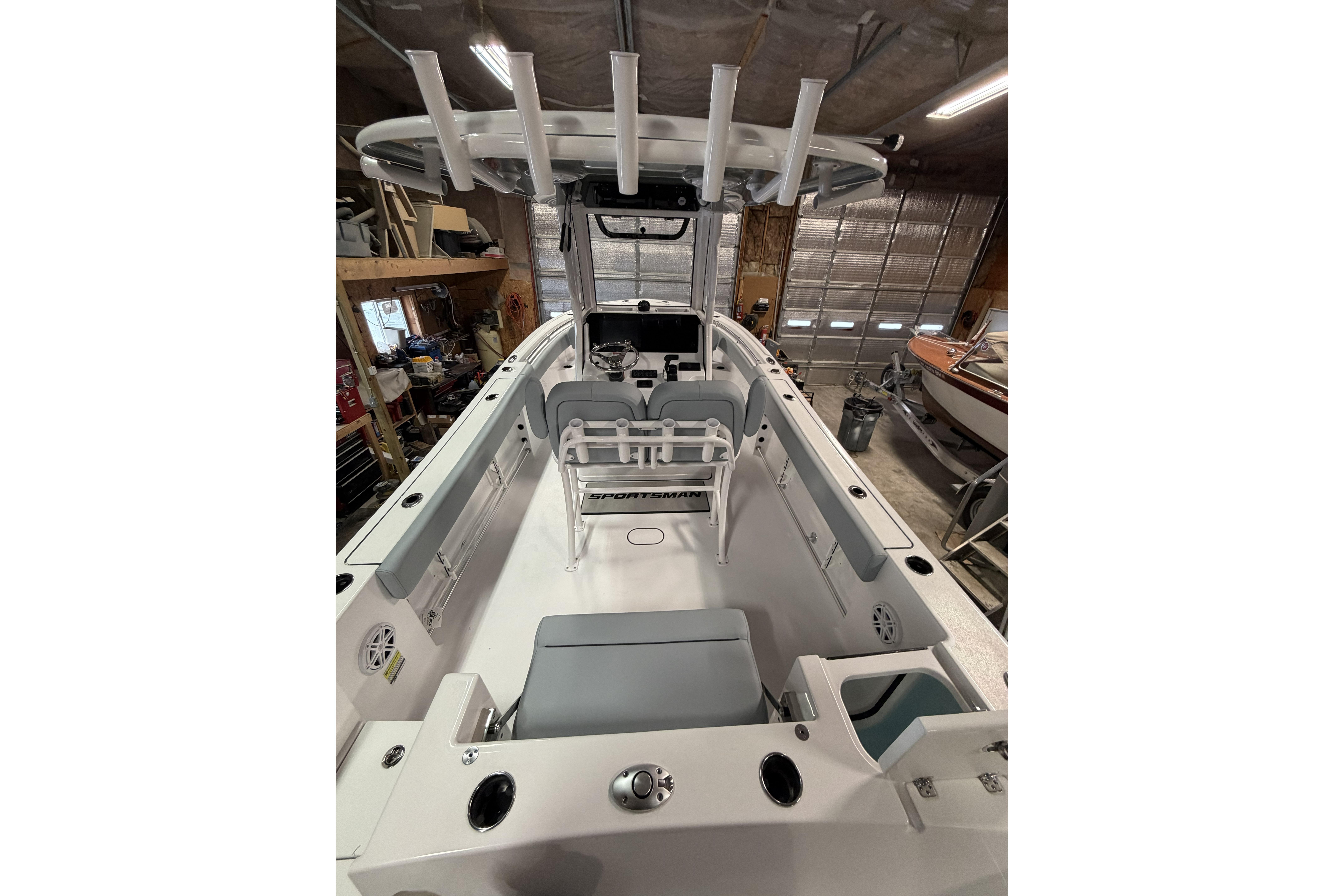 2026 Sportsman Open 232 Center Console boat interior in a garage setting.