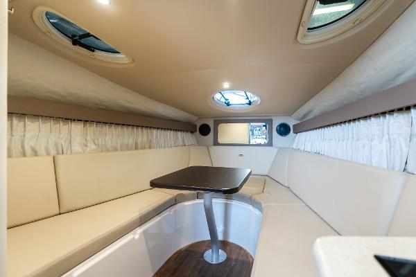 2016 Regal 28 Express cabin interior with beige seating and table.