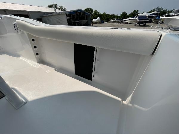 2025 Tidewater 232 CC Adventure boat interior, featuring sleek white seating and storage compartment.