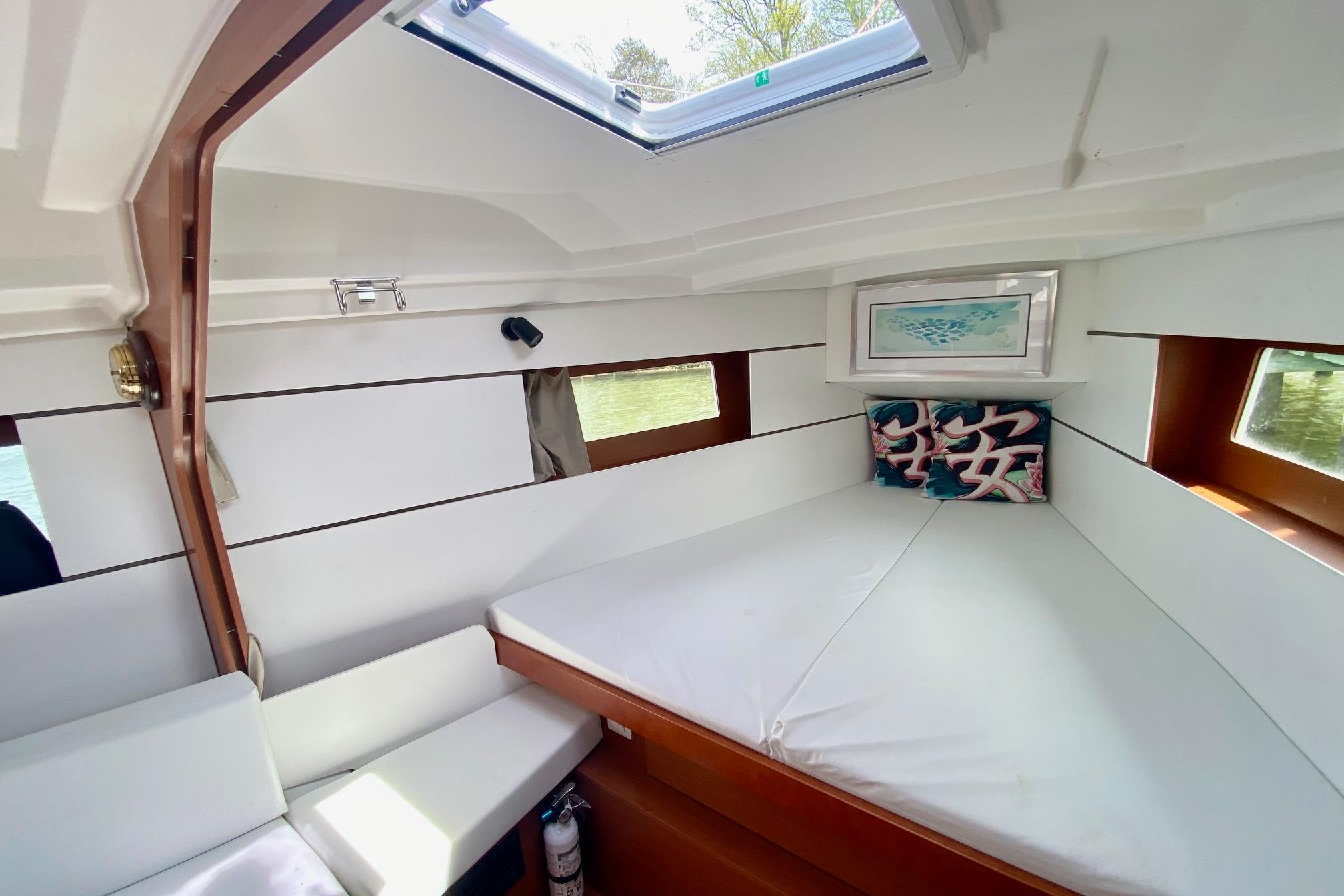 Cozy interior cabin of 2016 Beneteau Oceanis 35 sailboat with modern decor and natural light.