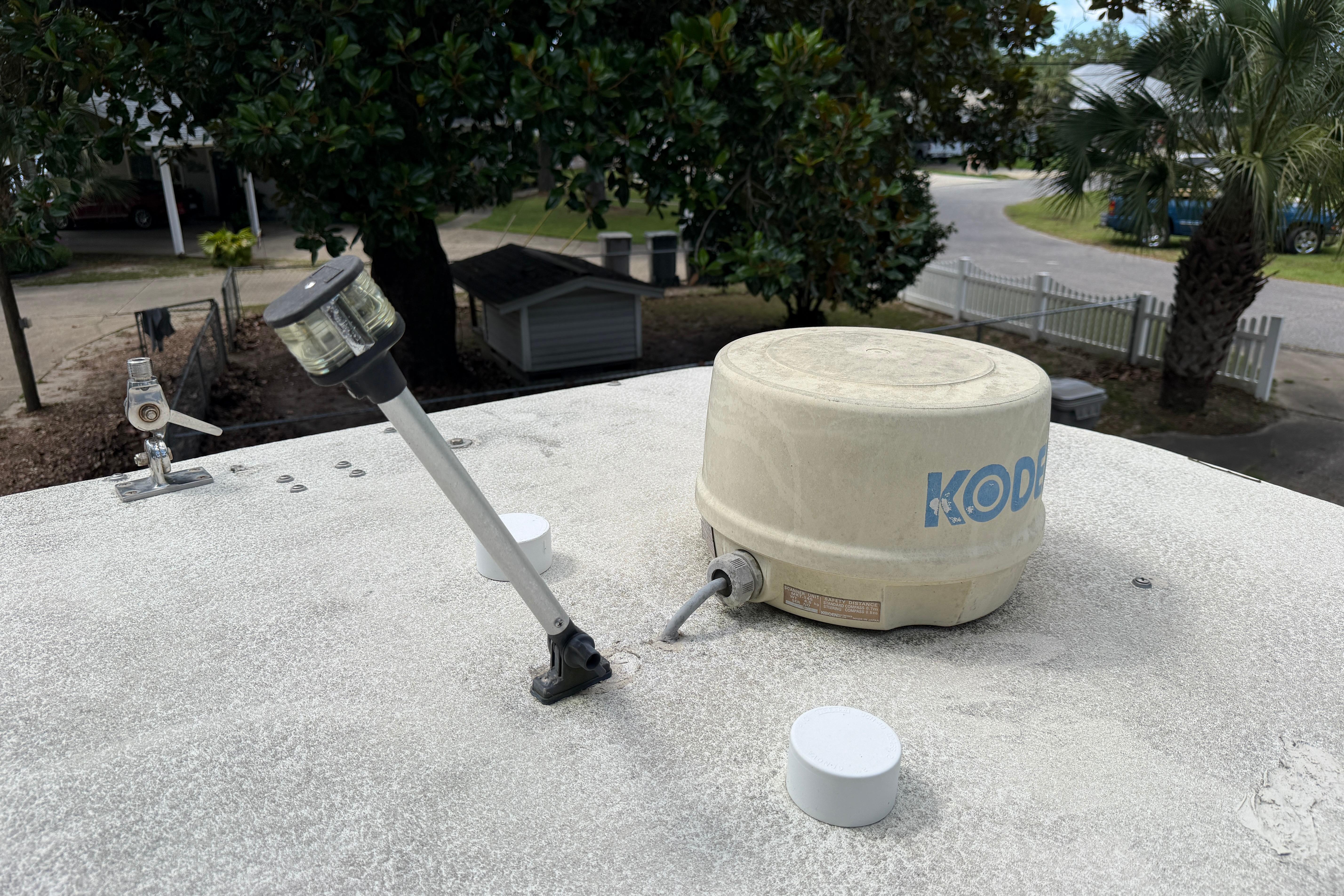 Rooftop equipment on a Grady-White Seafarer 226 boat, 1987 model, with trees in the background.
