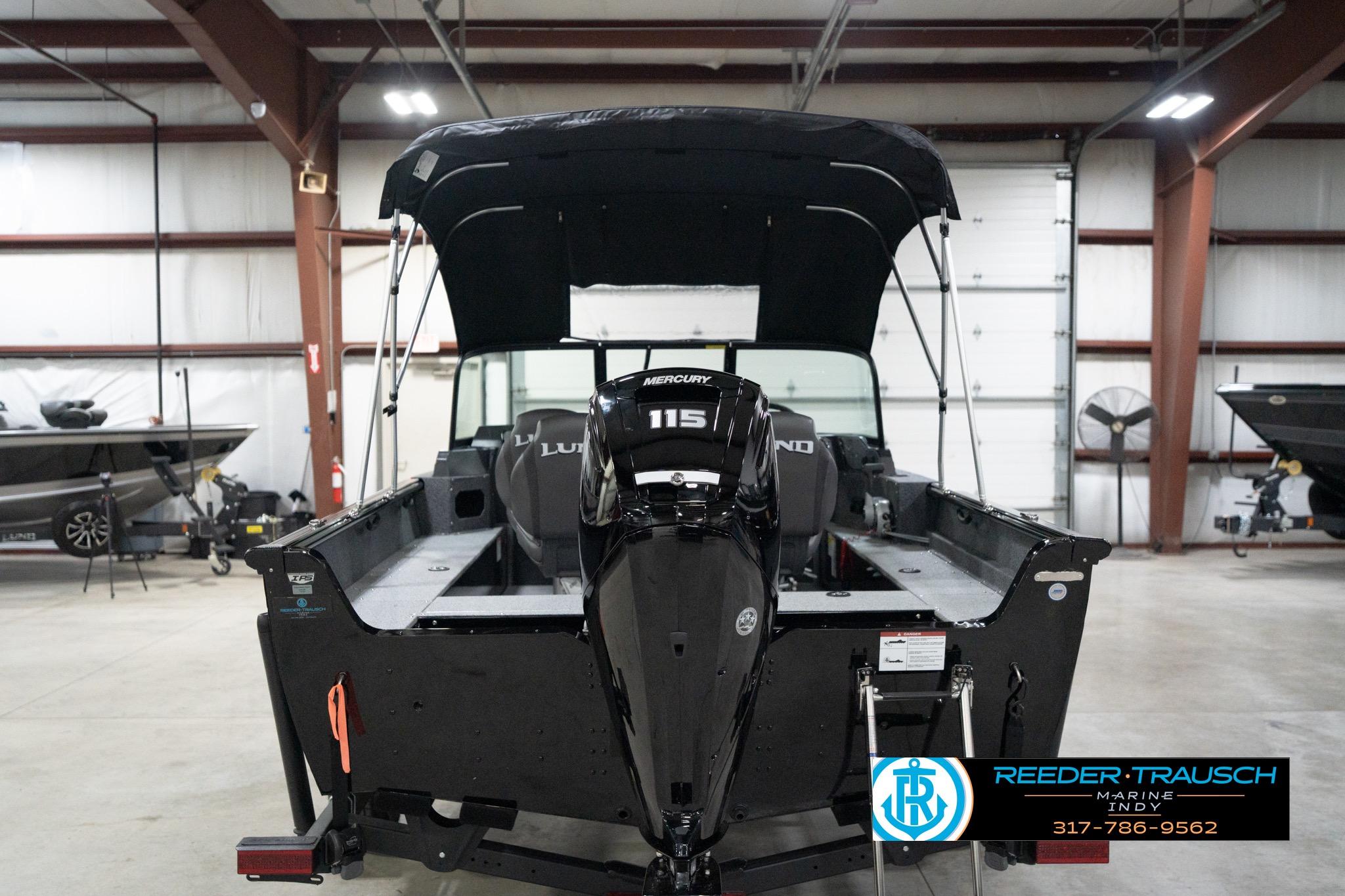 2026 Lund 1800 Explorer Sport boat with Mercury 115 engine in showroom.