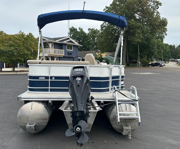 A 2018 South Bay S224CR pontoon boat with a blue canopy and outboard motor.