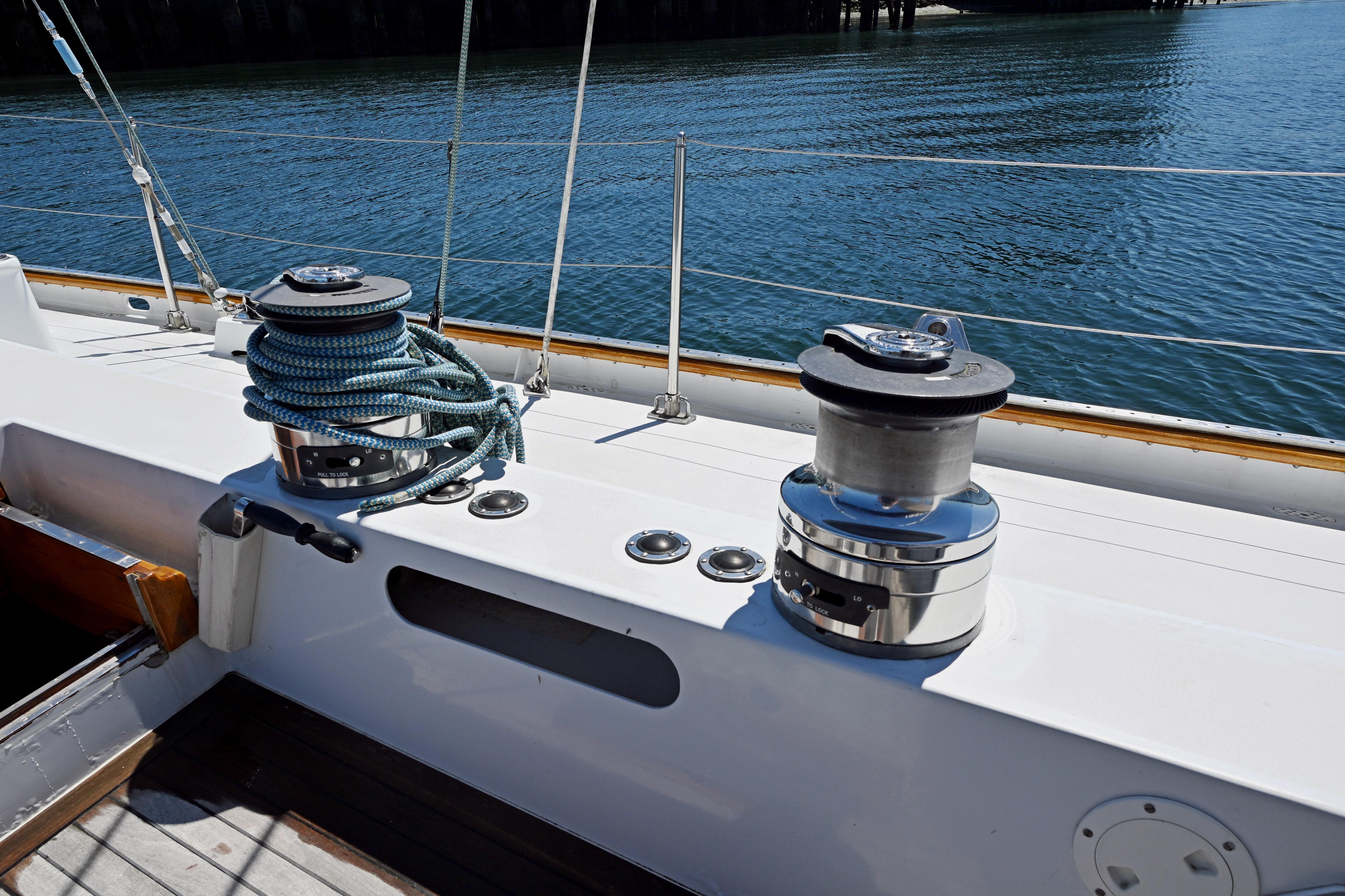 Deck of 1968 Abeking & Rasmussen Tripp 74 yacht with winches and ropes.