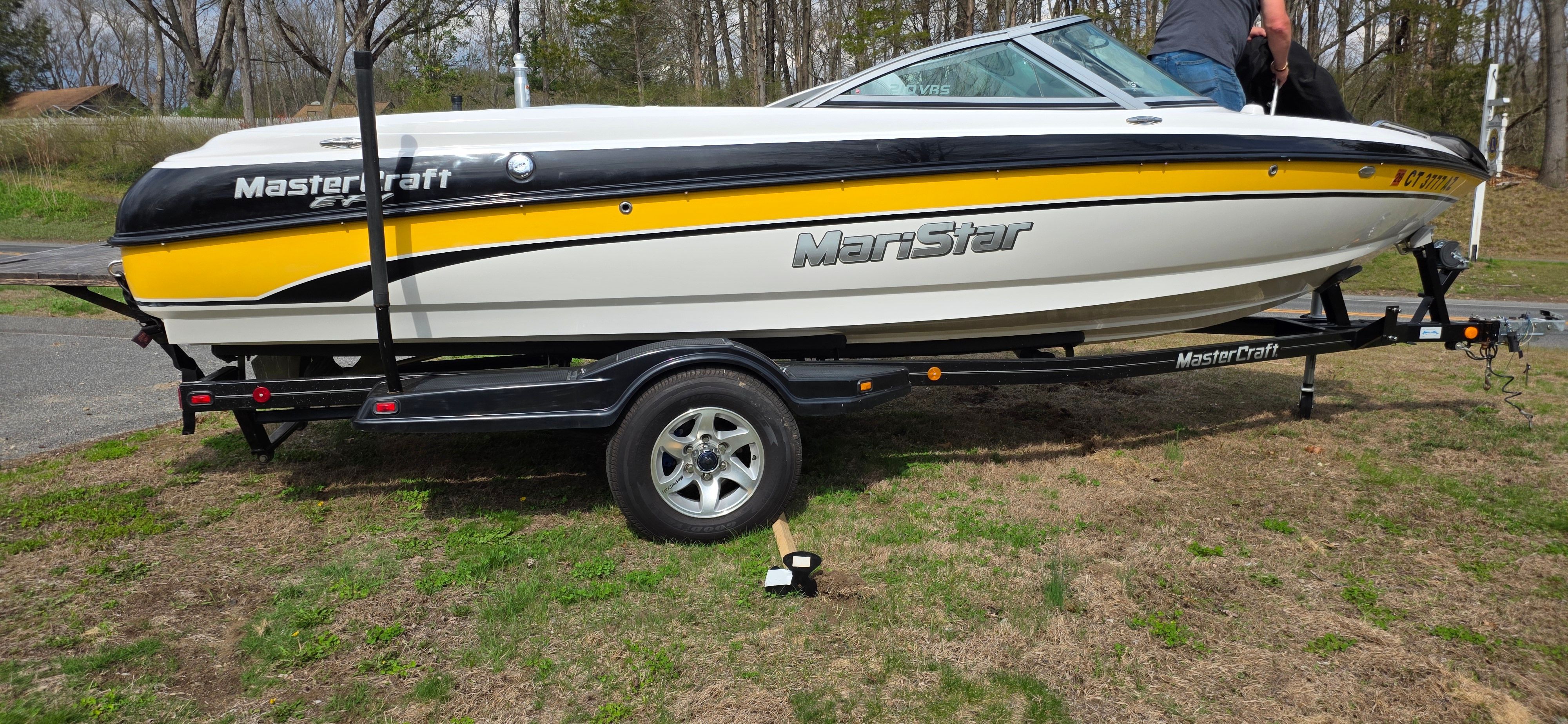 2004 MasterCraft Maristar boat on trailer, yellow and white design.