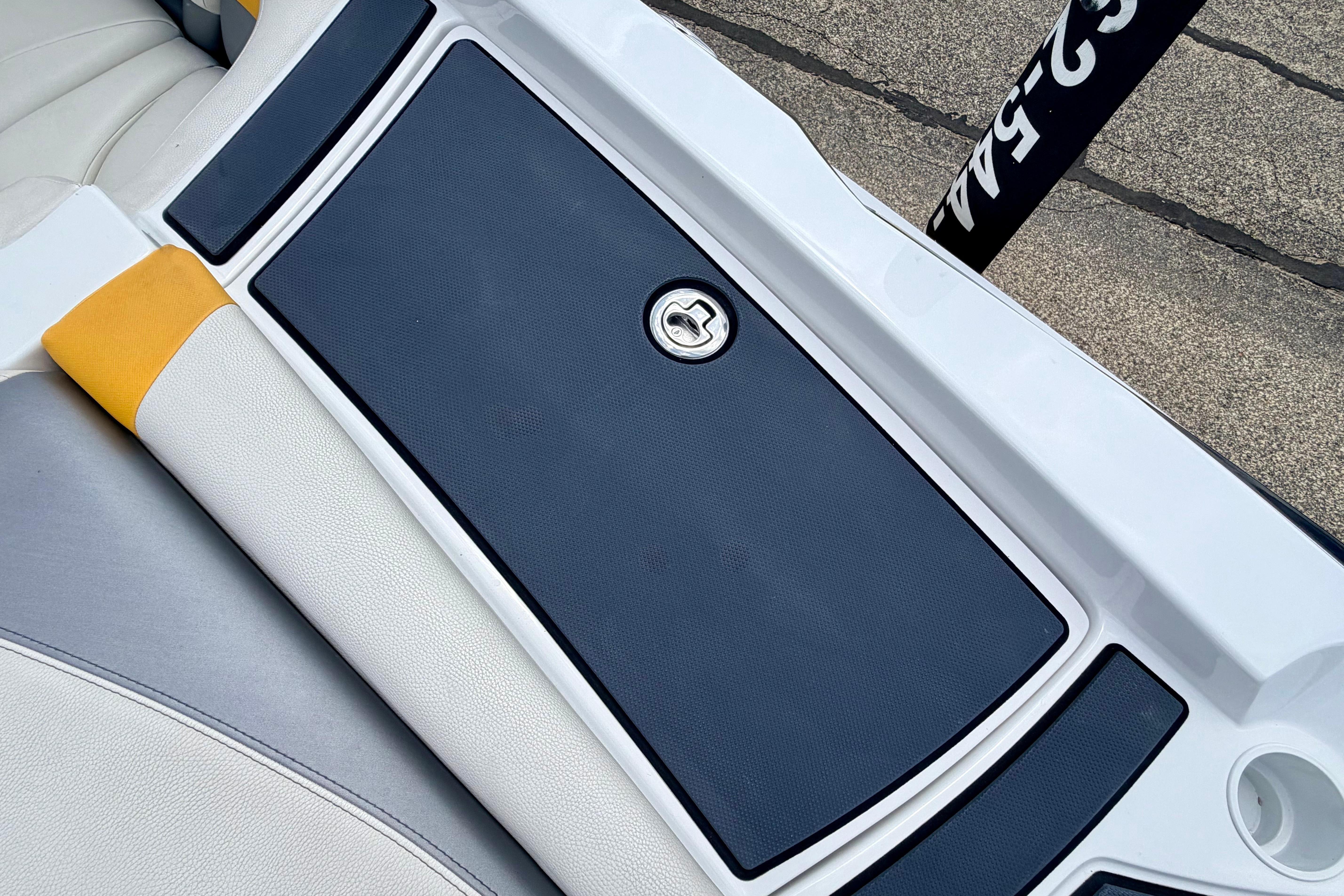 Close-up of a boat deck with gray padding and white trim.