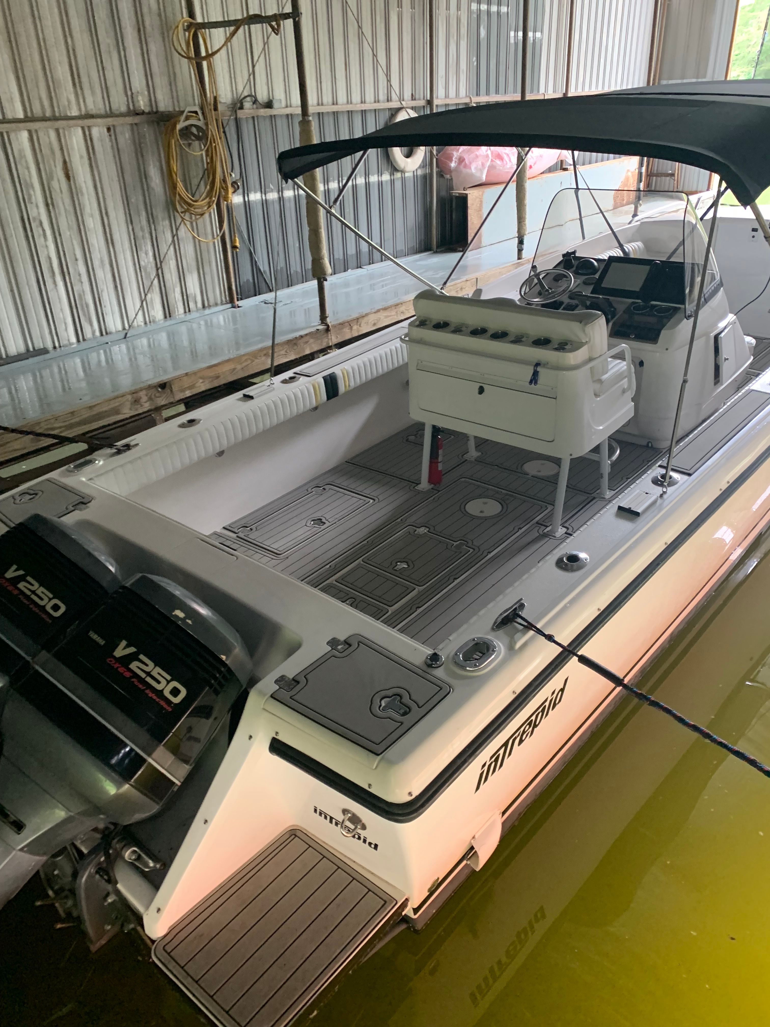 2002 Intrepid 322 Cuddy Center Console boat in a dock.