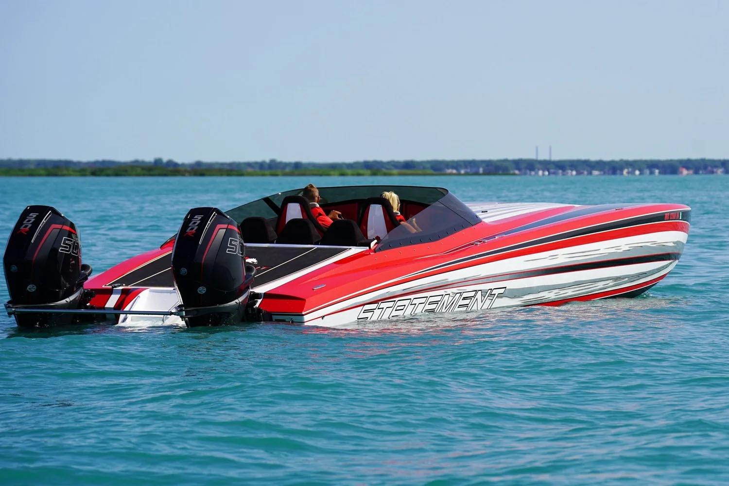 Manufacturer Provided Image: Red and white Statement 360 CAT speedboat on blue water, featuring dual outboard engines.