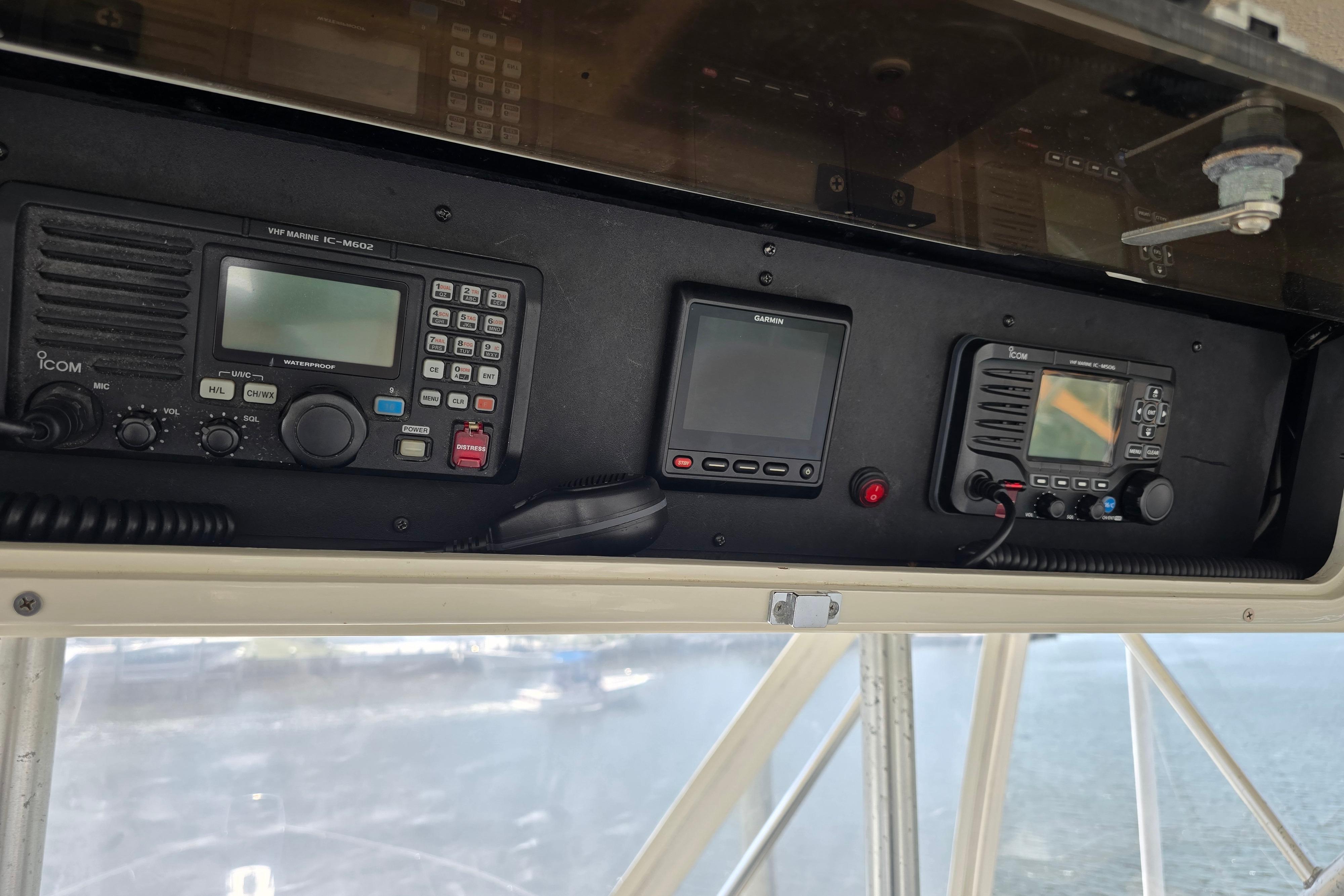 Control panel of a 1988 Post 46 Convertible boat with marine radios and navigation equipment.
