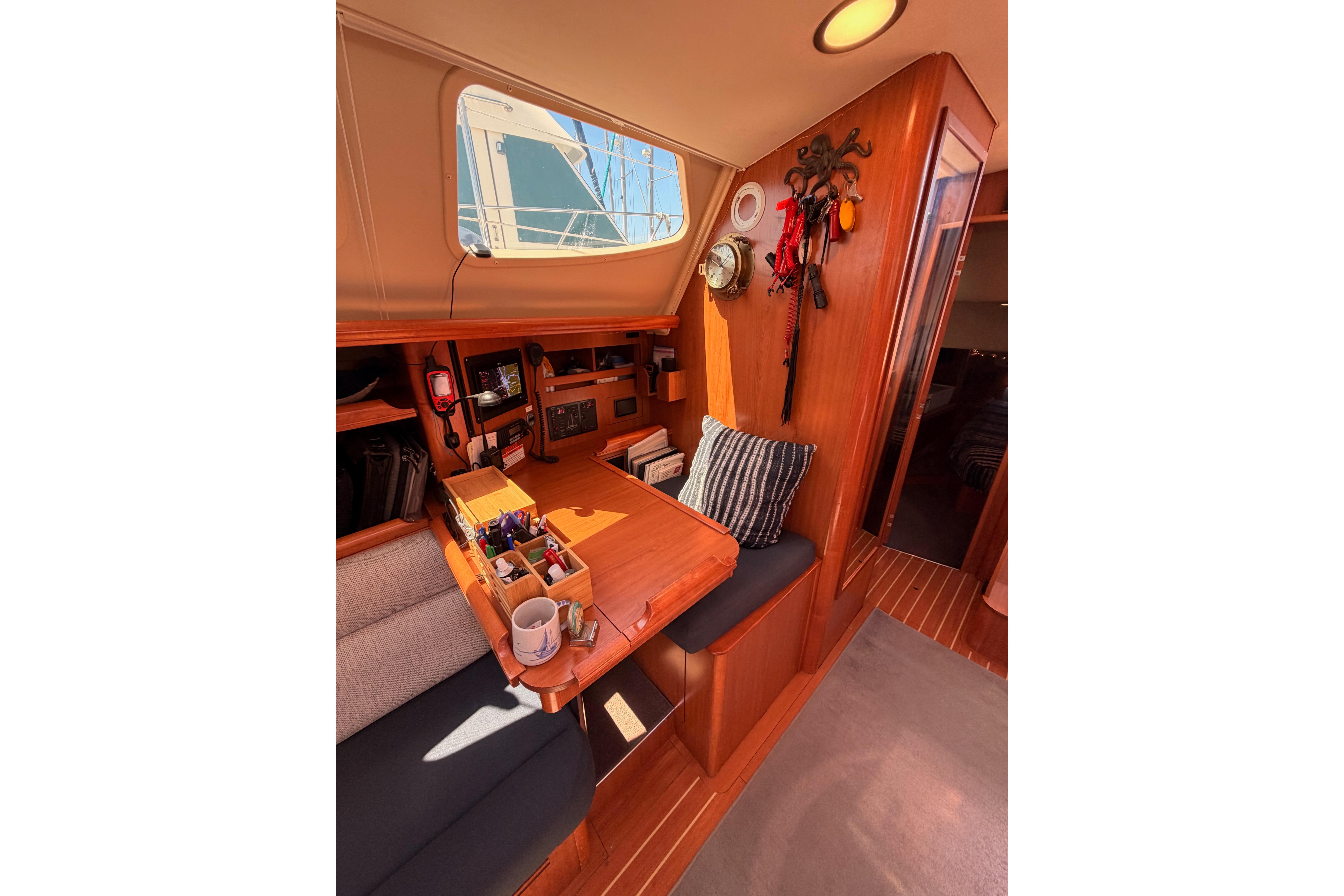 Interior of 2008 Hunter 45 Deck Salon, featuring a cozy navigation station and seating area.
