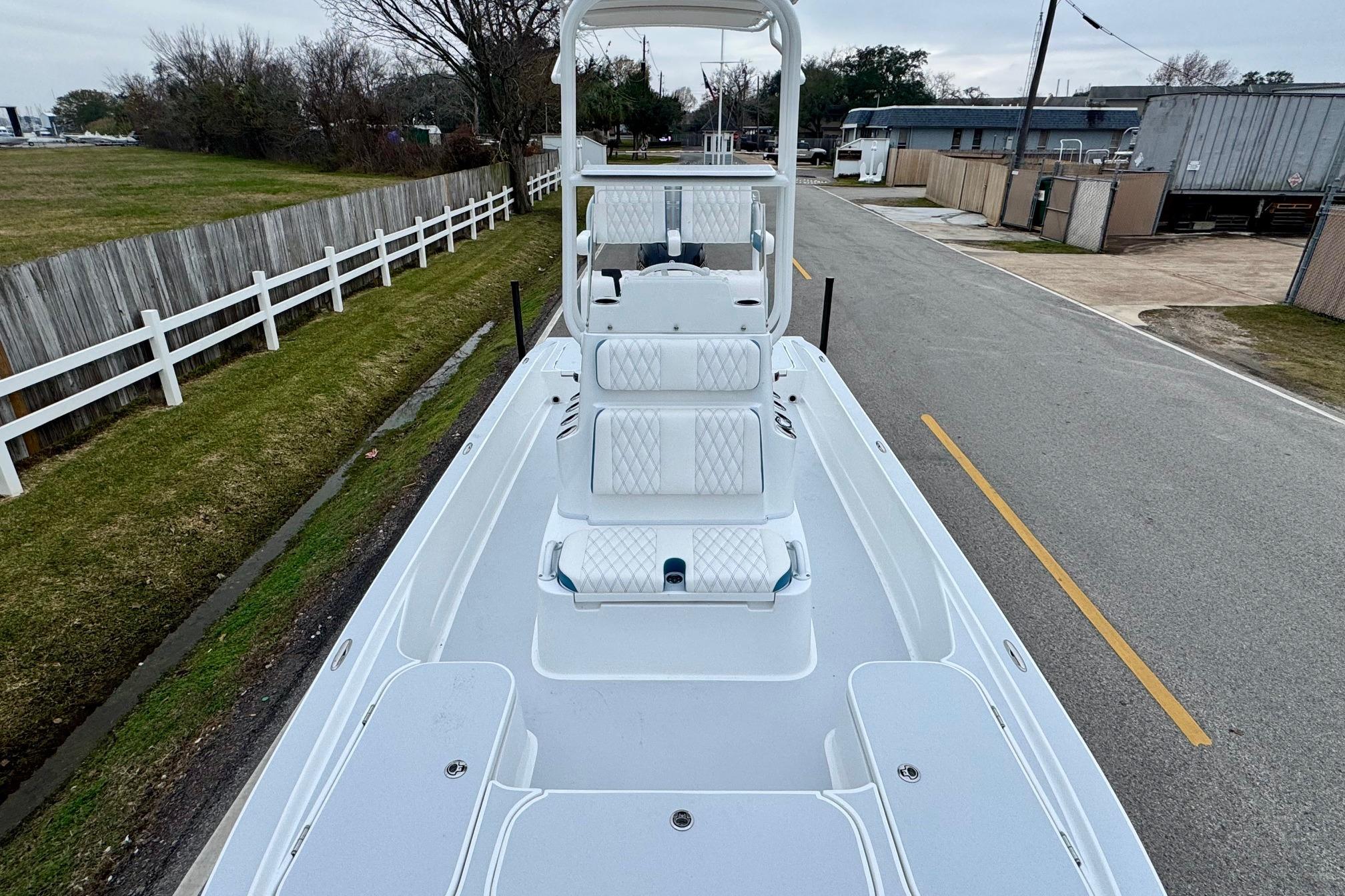 2026 Shallow Sport 24 Modified V boat on a road, showcasing deck and seating.