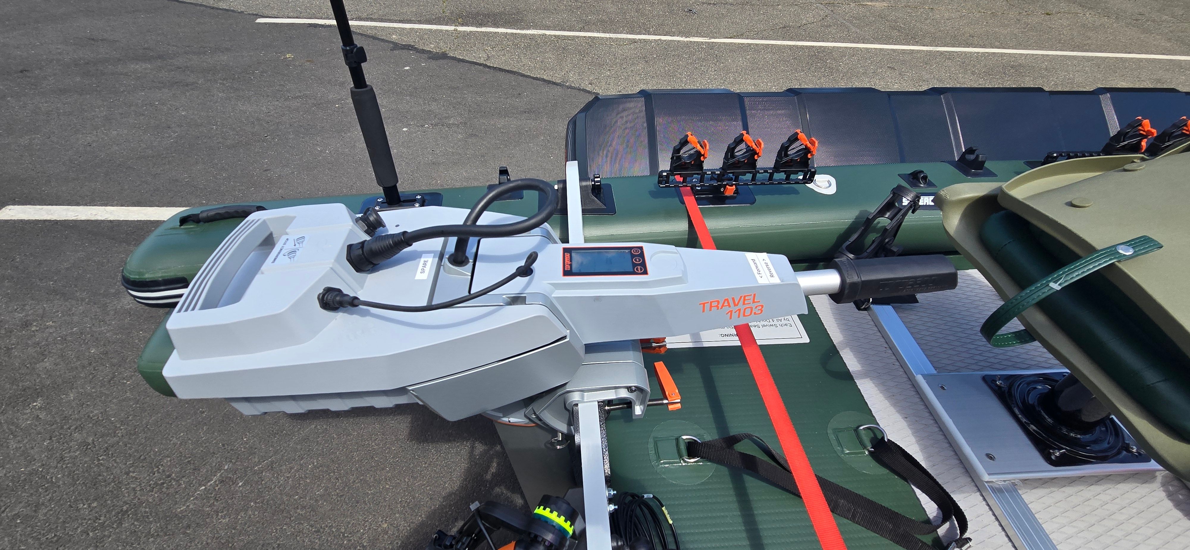 A Sea Eagle FSK16 boat with a modern motor and equipment on a parking lot.