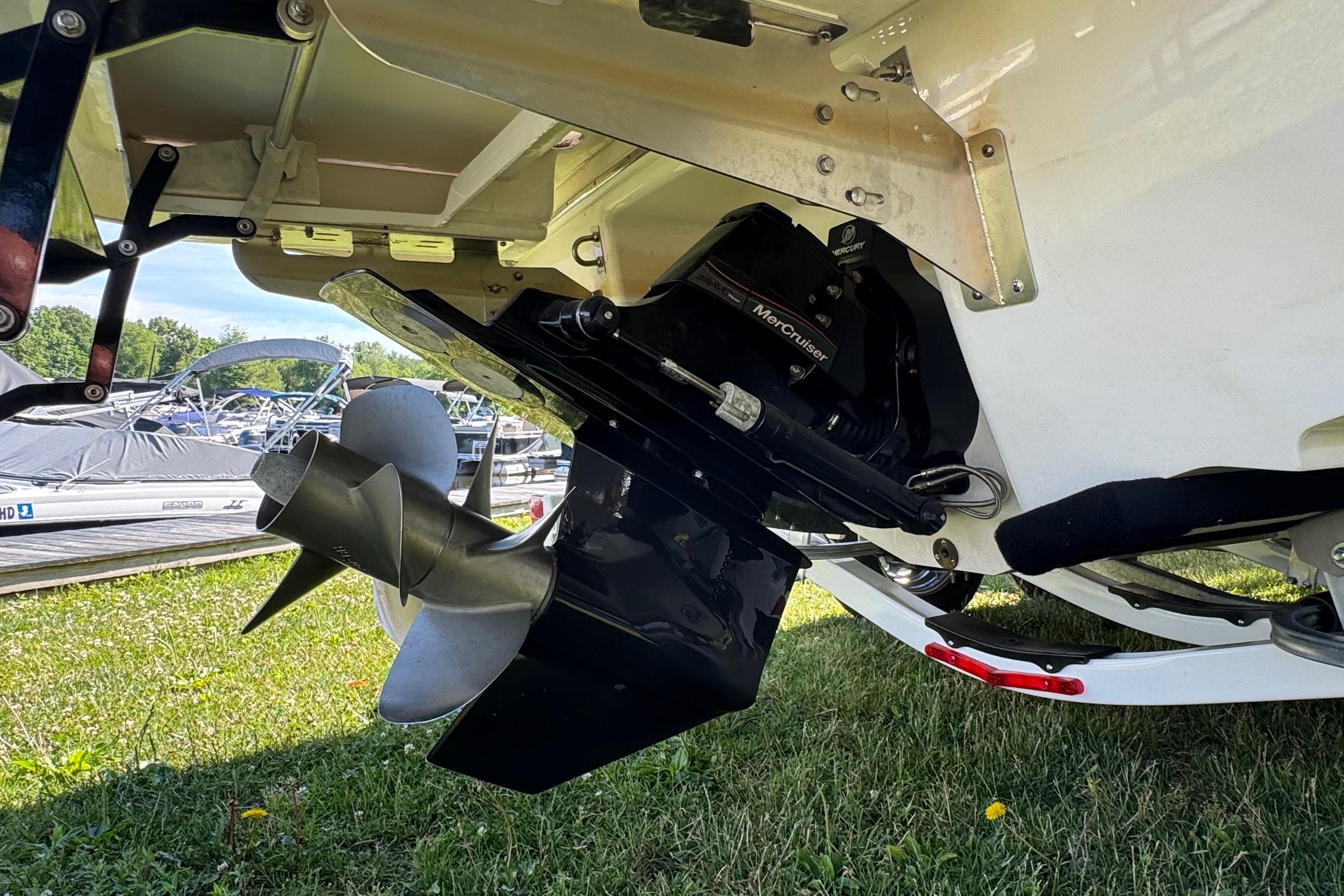 2026 Chaparral SSX 4 boat with MerCruiser engine and propeller, displayed on grass.