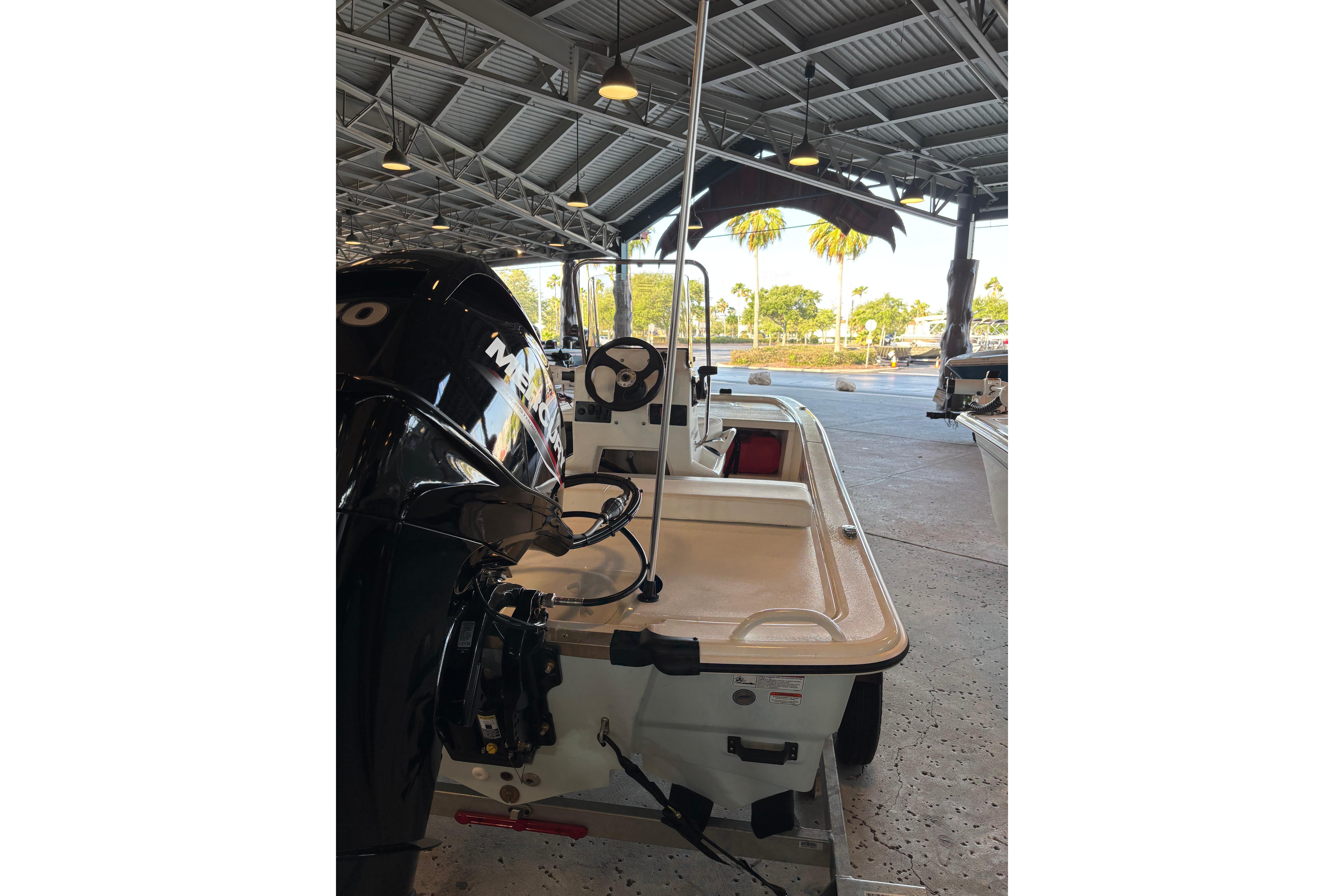 2026 Mako Pro Skiff 13 CC boat in a covered marina setting.