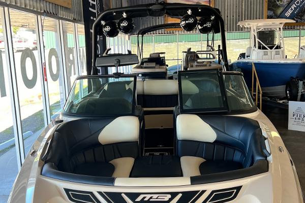 2024 MB F22 Tomcat boat interior with black and white seating in showroom.