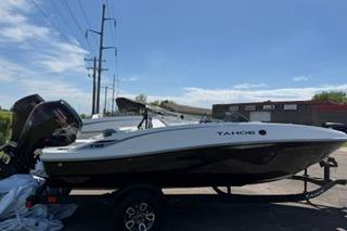 2026 Tahoe T18 boat on trailer, parked outdoors under clear sky.