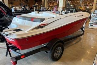 2026 Tahoe T18 boat in showroom, featuring sleek red and white design on trailer.