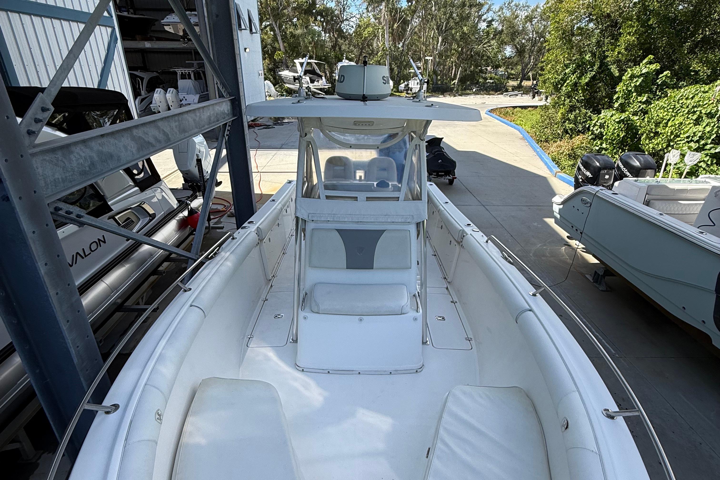 2008 Century 2901 Center Console boat docked, featuring spacious seating and modern design.