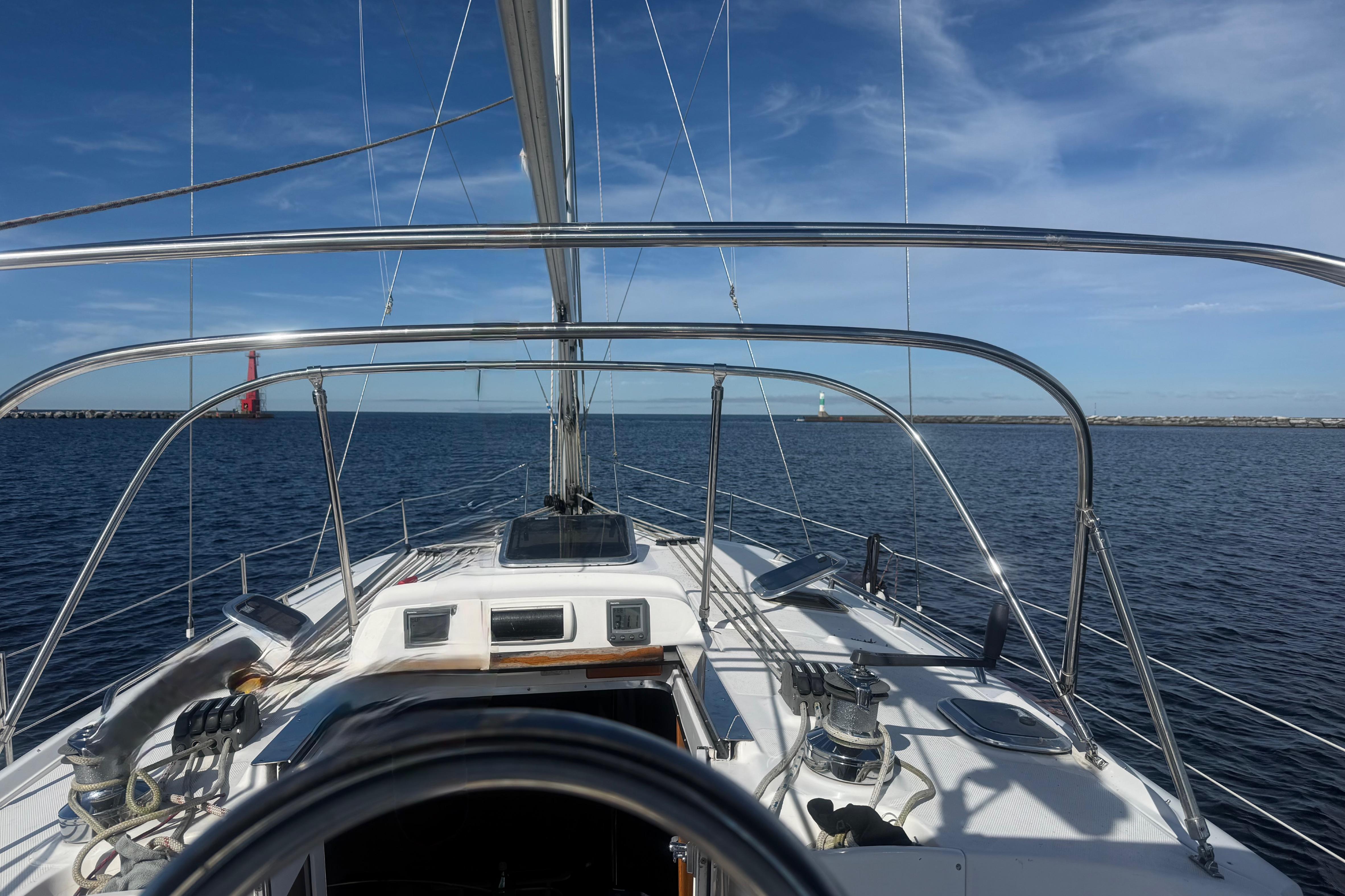 2007 Hunter 41 Deck Salon sailboat on open water under clear blue skies.