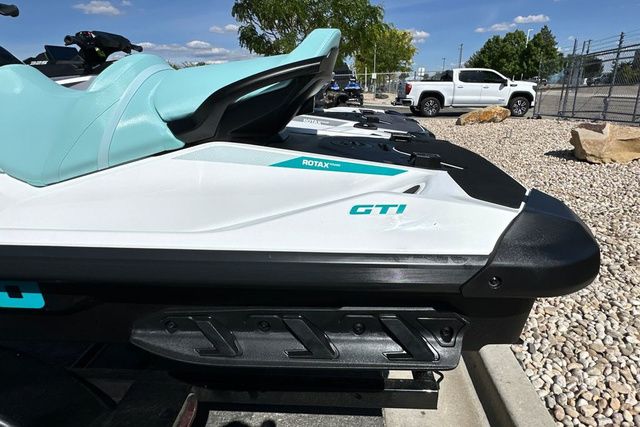 2026 Sea-Doo PWC GTI 130 WH IBR 26 STD with turquoise seat in a parking lot.